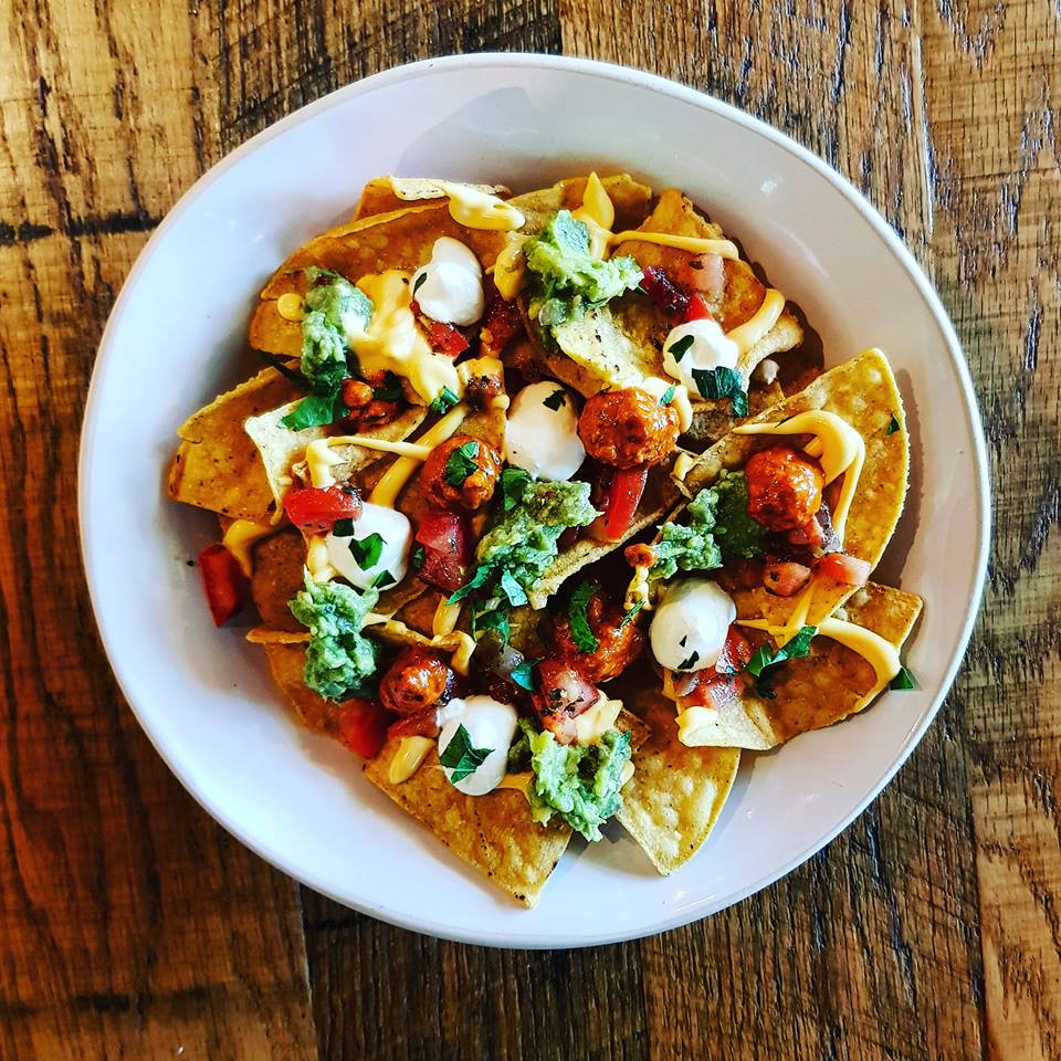 Vibrant nachos with guacamole and salsa for networking events and gatherings.