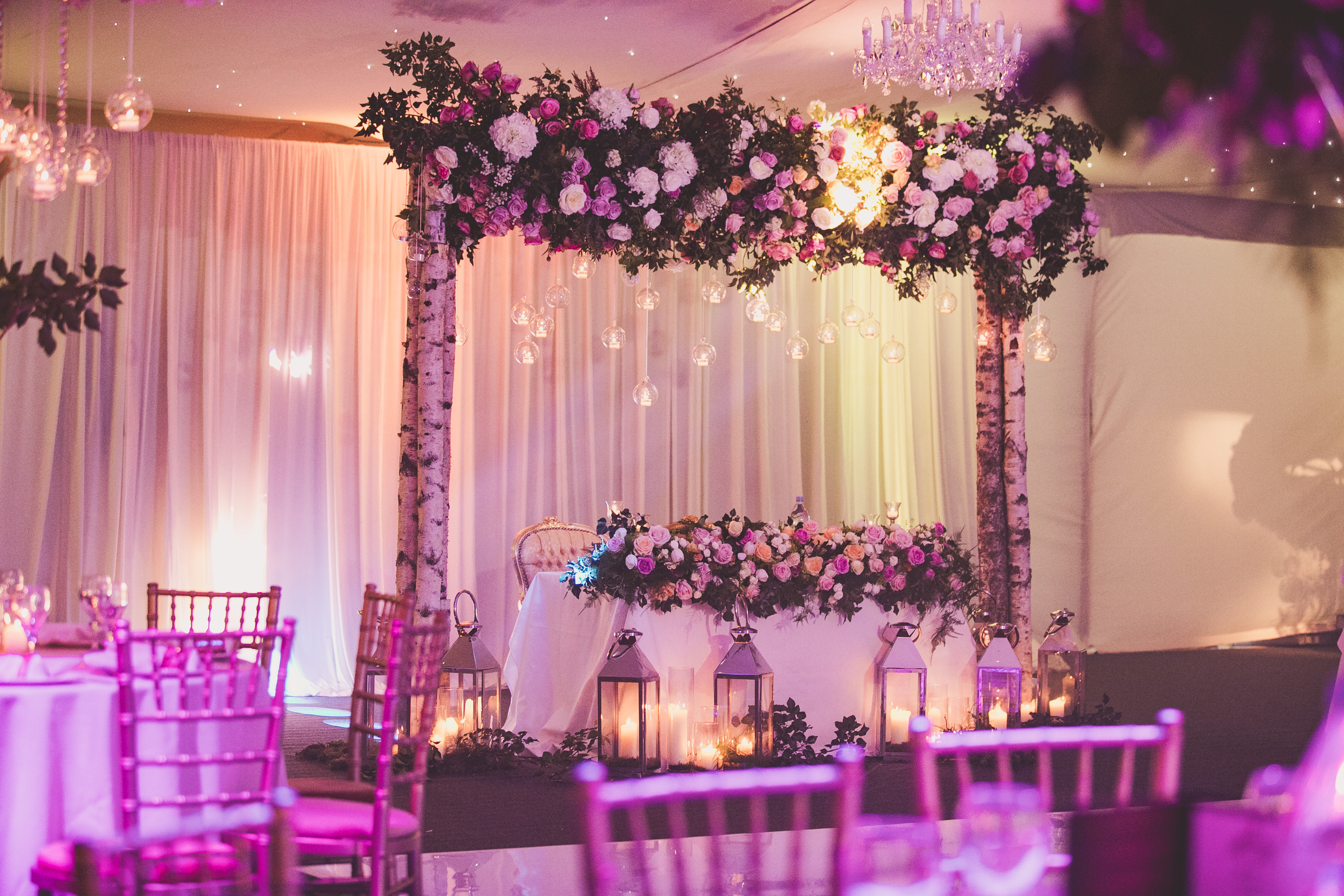 Elegant garden marquee with floral arch, ideal for weddings and celebrations.