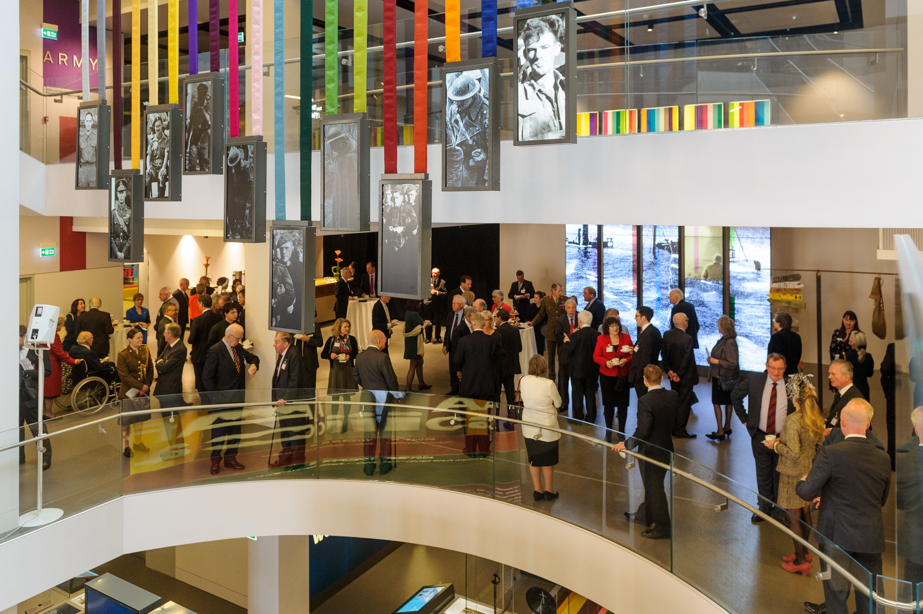 Vibrant networking event in National Army Museum foyer with colorful decor and art.