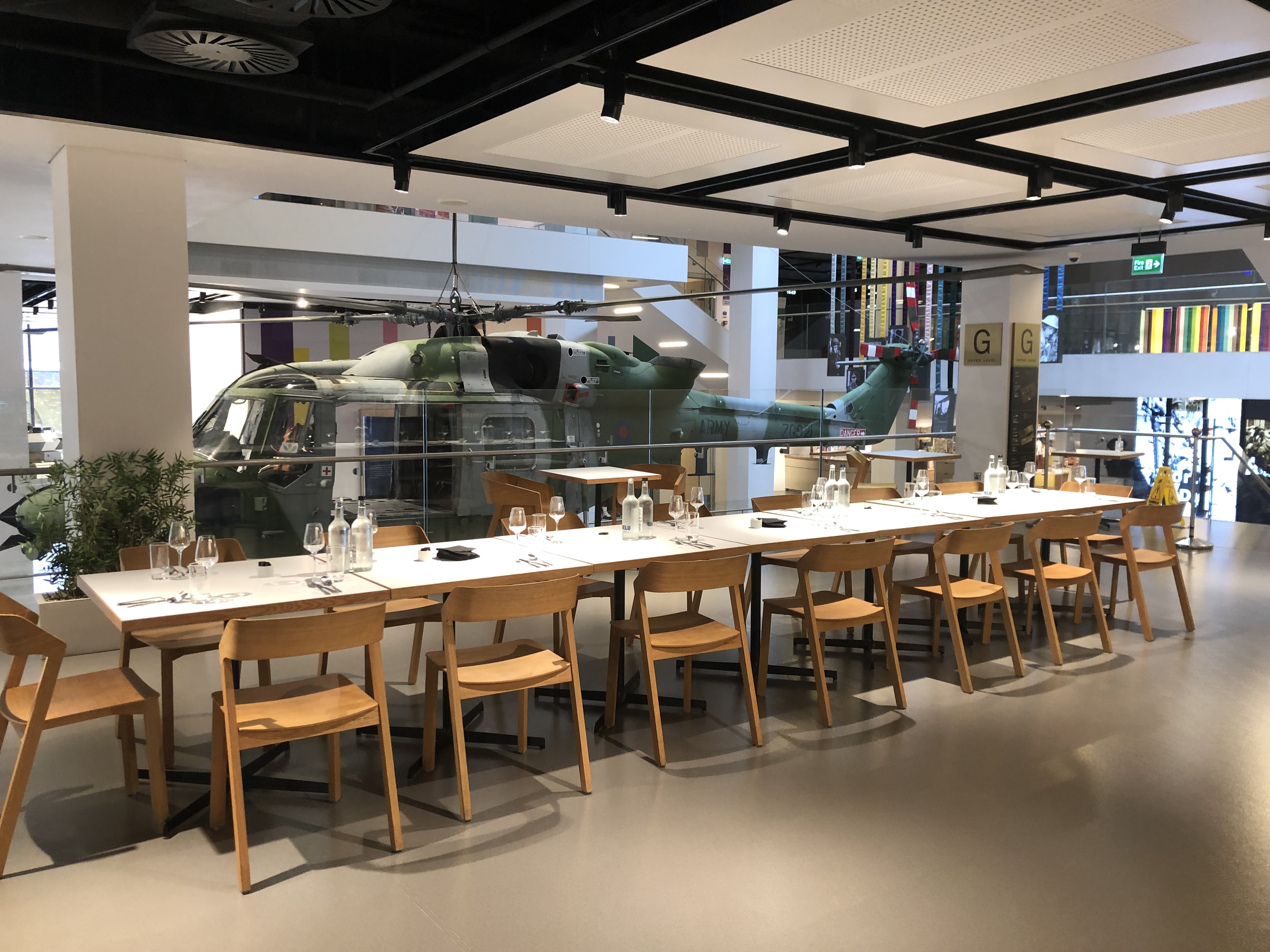 Cafe in National Army Museum with helicopter backdrop, ideal for corporate events.