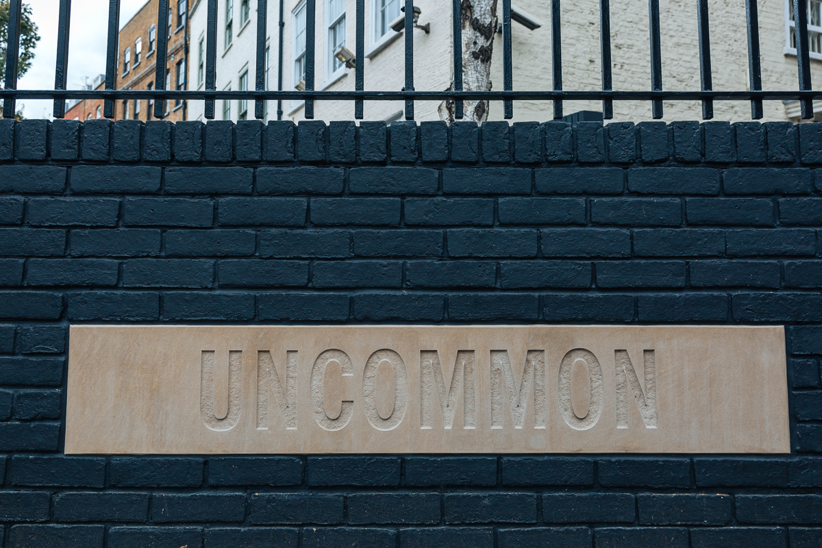 "Uncommon Fulham Meeting Room with textured 'UNCOMMON' sign for unique events"