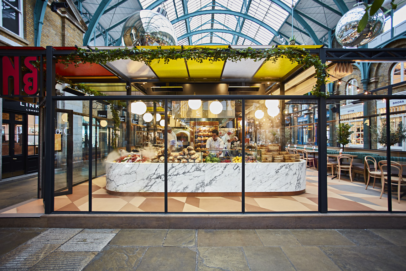 Vibrant Main Restaurant at Buns&Buns with marble counter, ideal for events and gatherings.