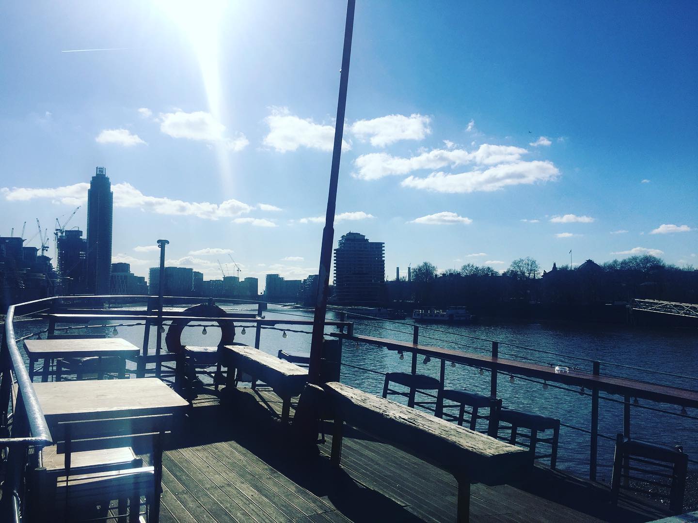 West-Facing Deck at Tamesis Dock, sunlit riverside venue for outdoor events and gatherings.