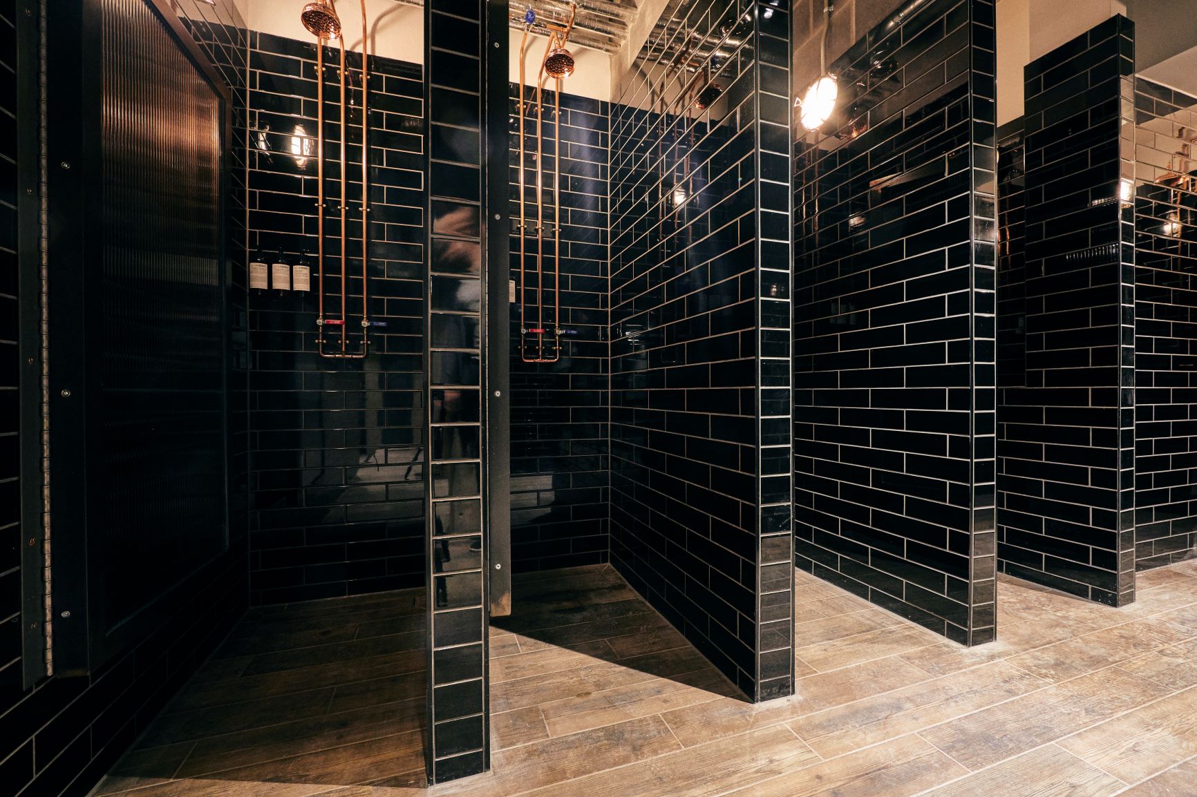 Modern restroom with sleek black tiles at SPACE, Victus Soul Limited for events.
