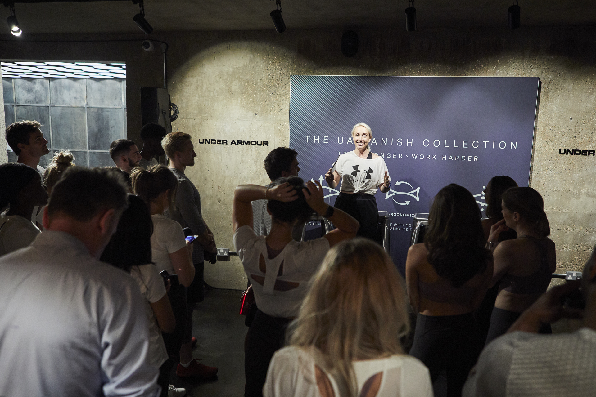 Dynamic speaker engaging audience in modern event space for networking and brand storytelling.