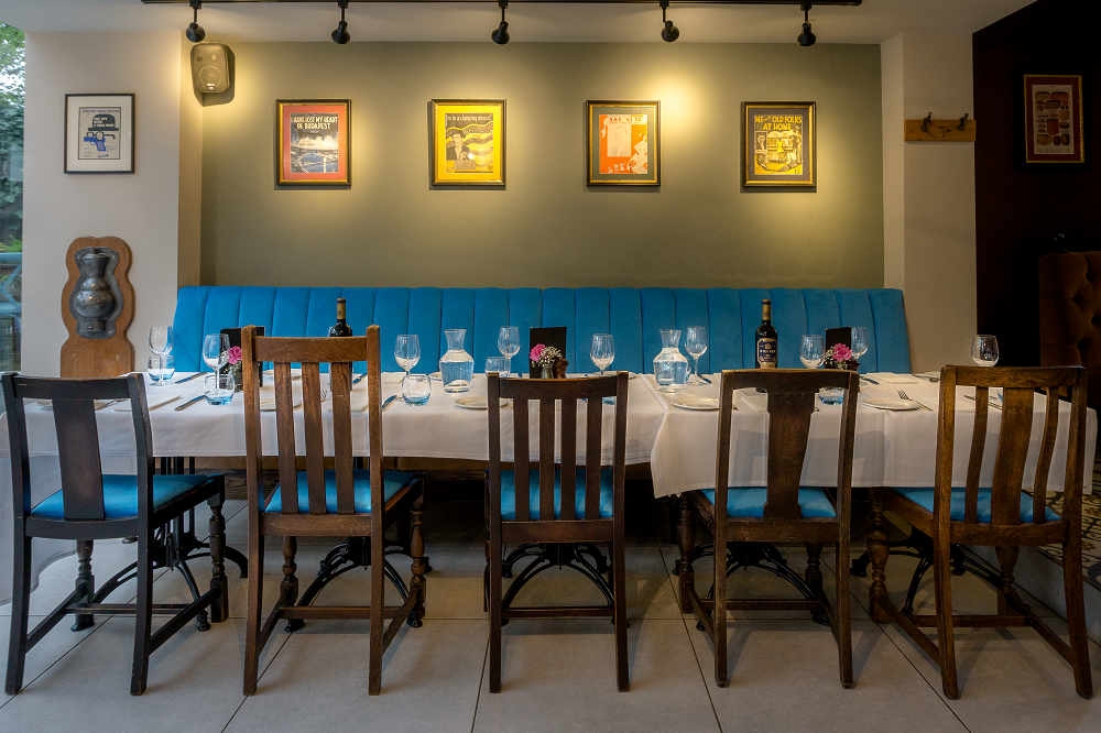 Ceylon Room dining setup with blue seating for intimate events and networking dinners.