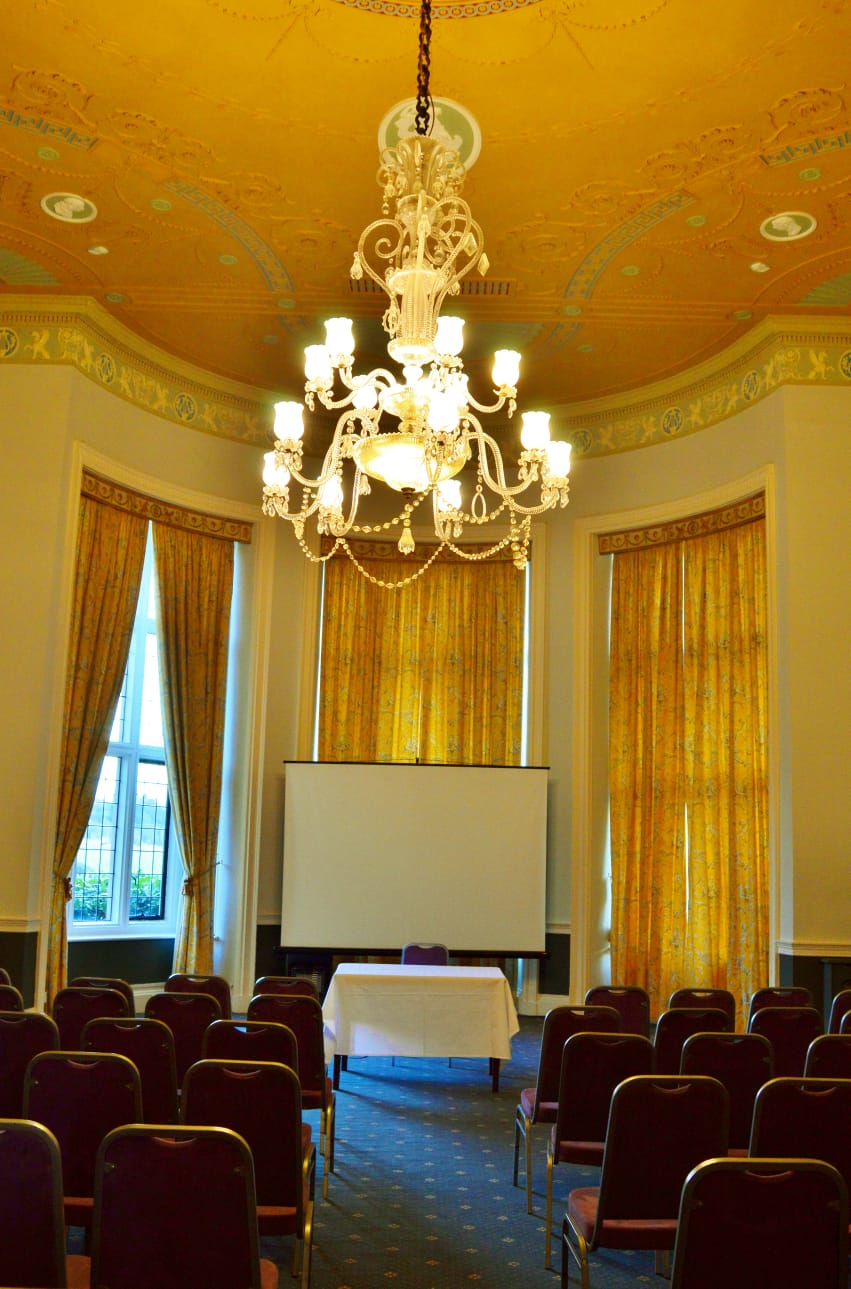 Elegant Georgian Room at Broome Park Hotel with chandelier, perfect for meetings and workshops.
