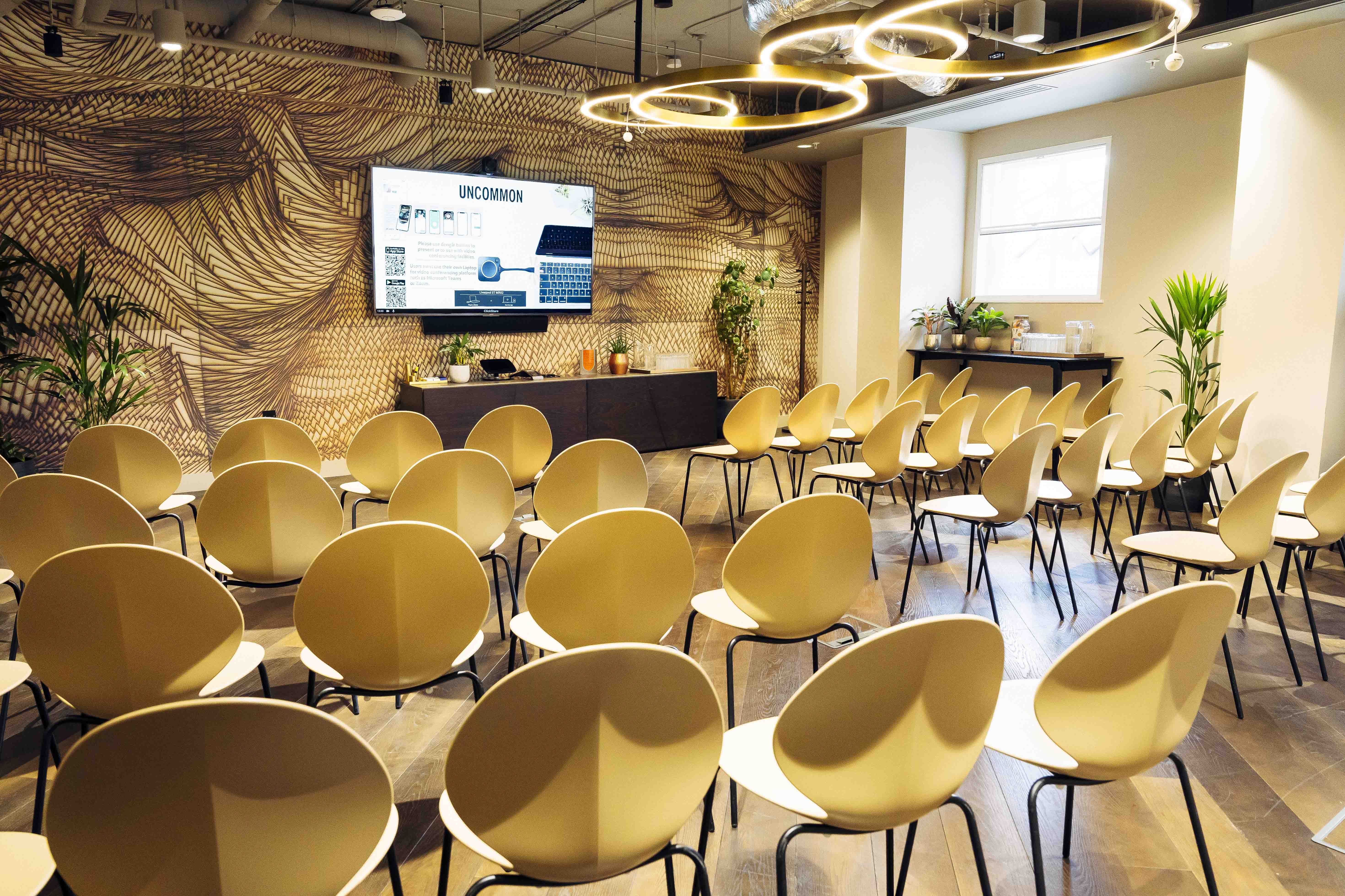 Modern meeting room with screen and greenery, perfect for presentations in Liverpool Street.