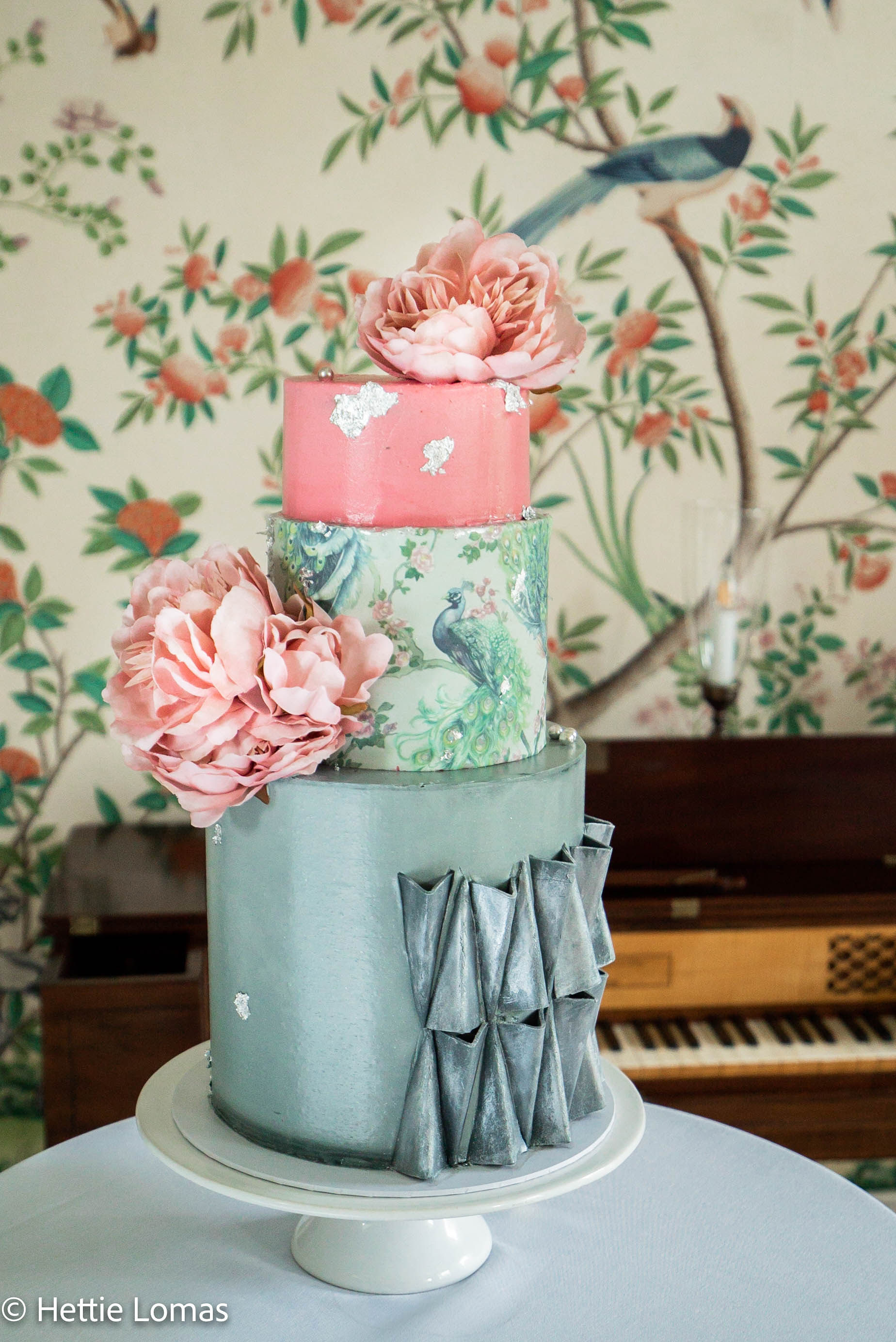 Elegant three-tier cake with floral patterns for upscale events at Pitzhanger Manor.
