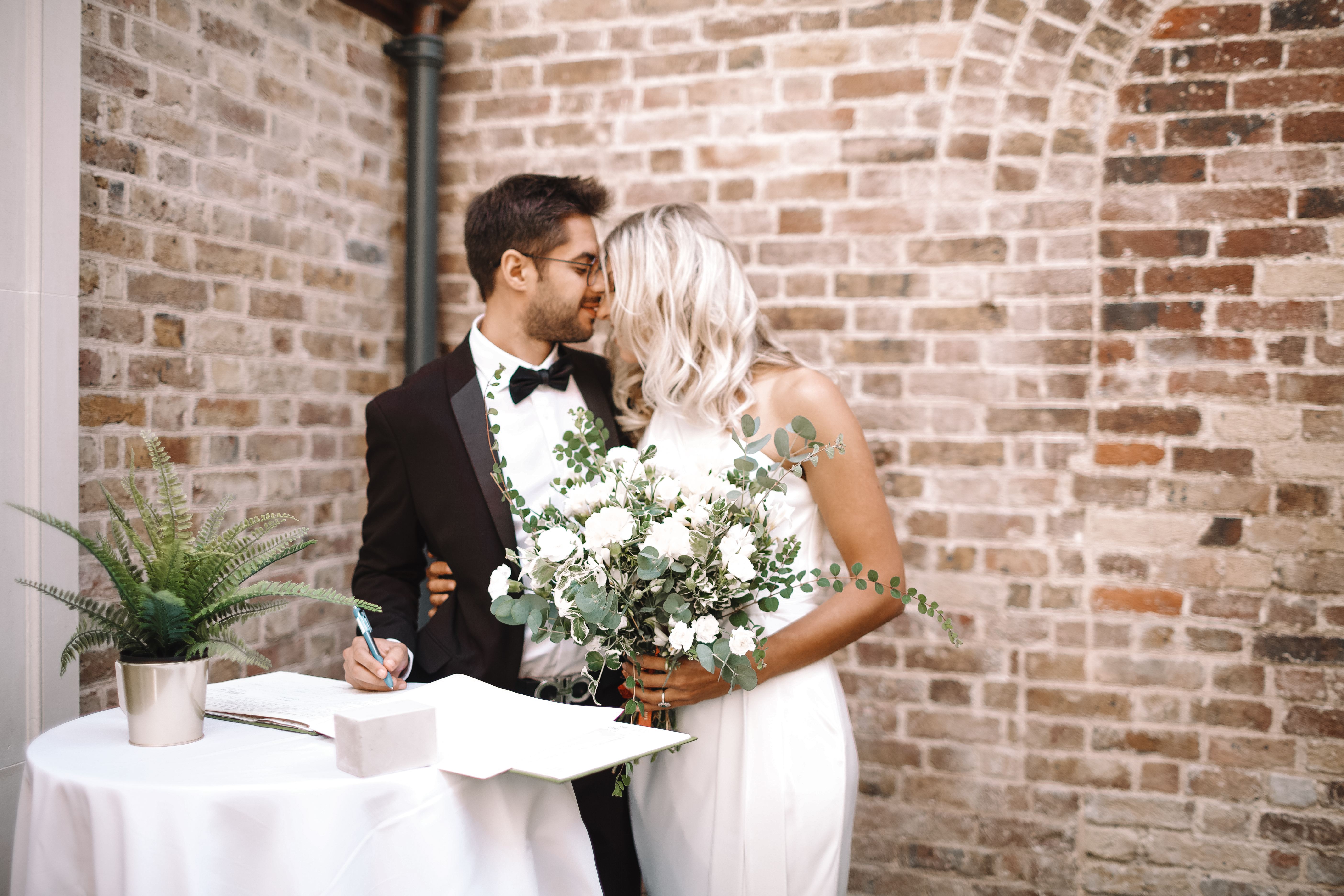Couple in elegant attire at wedding ceremony in The Colonnade, Pitzhanger Manor.