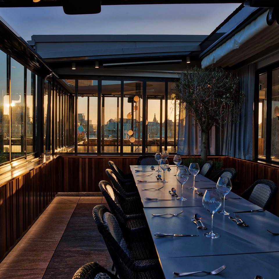 Stylish rooftop dining at The Rooftop ROOM, perfect for events with panoramic city views.
