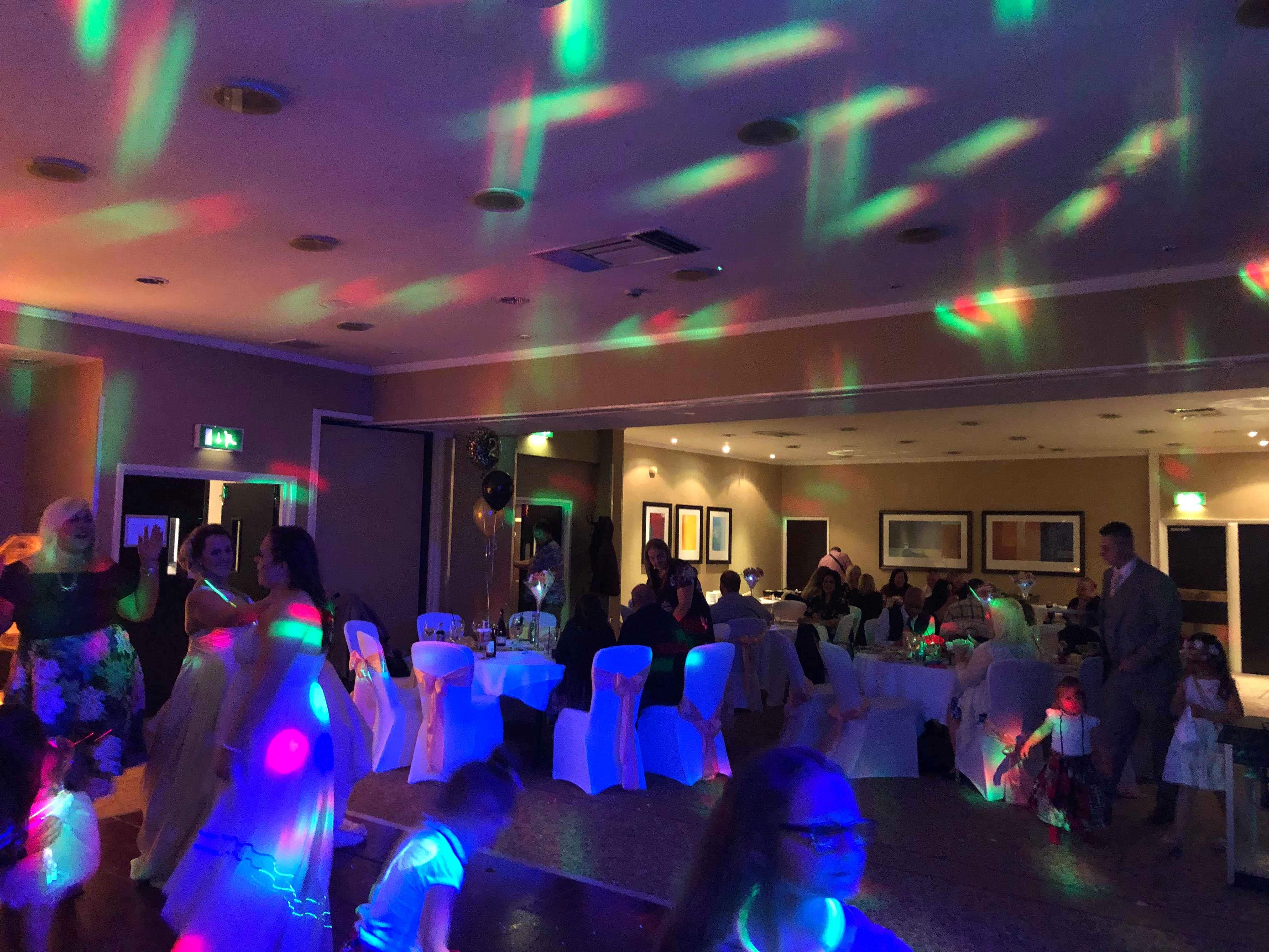 William Duesbury at vibrant Holiday Inn event space, lively atmosphere for celebrations.