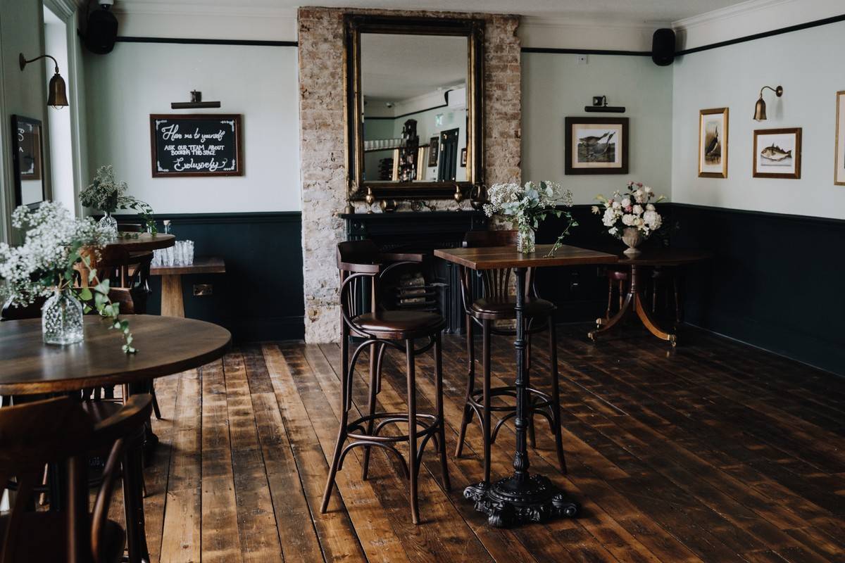 Stylish event space with rustic floors, perfect for networking and intimate gatherings.