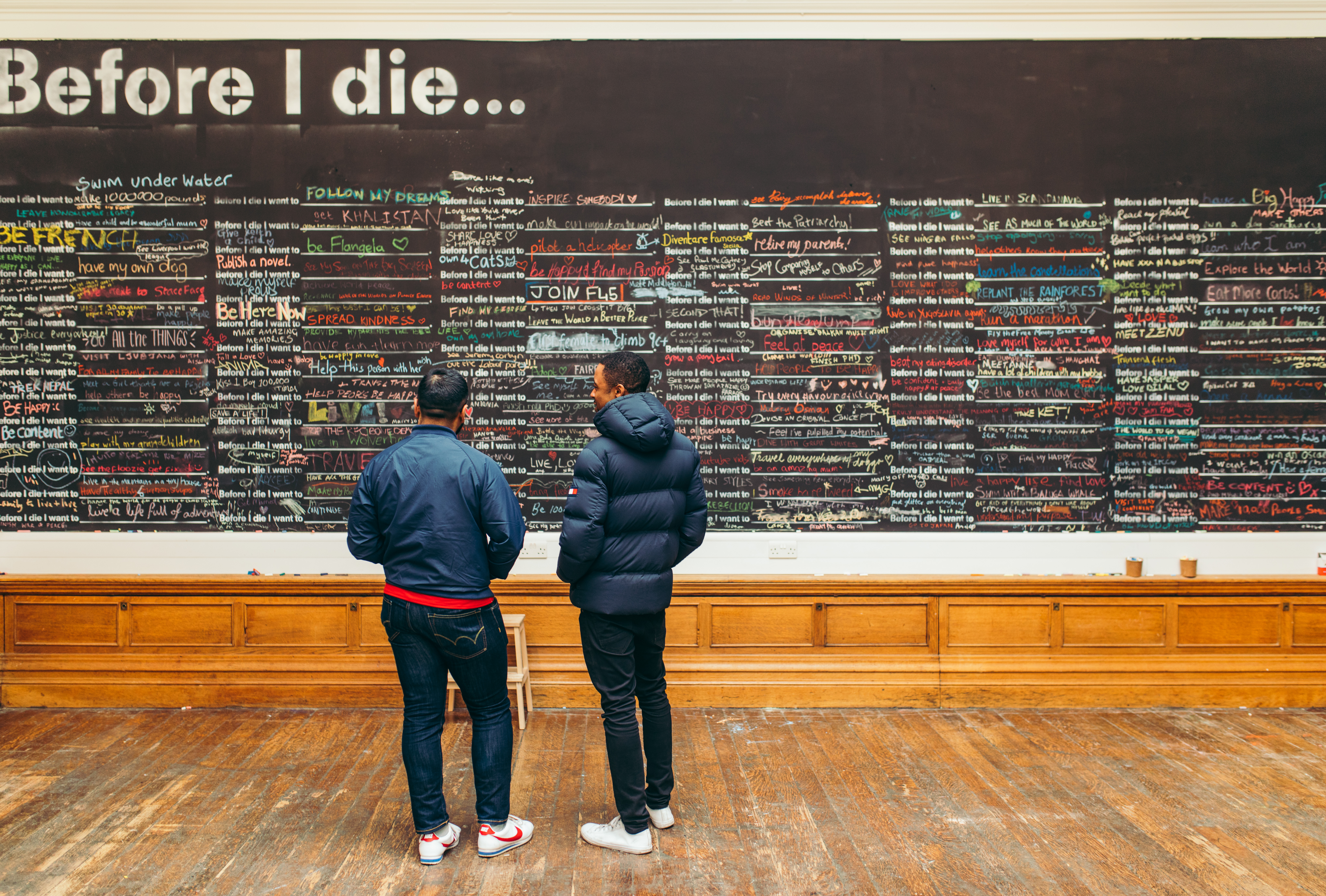 Interactive art installation "Before I Die" at Medicine Gallery, fostering community engagement.