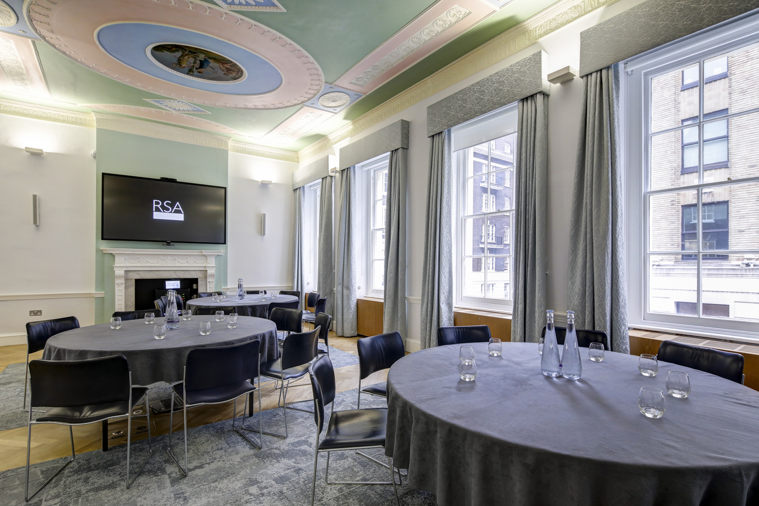 The Prince Philip Room at RSA House, featuring round tables for corporate meetings.