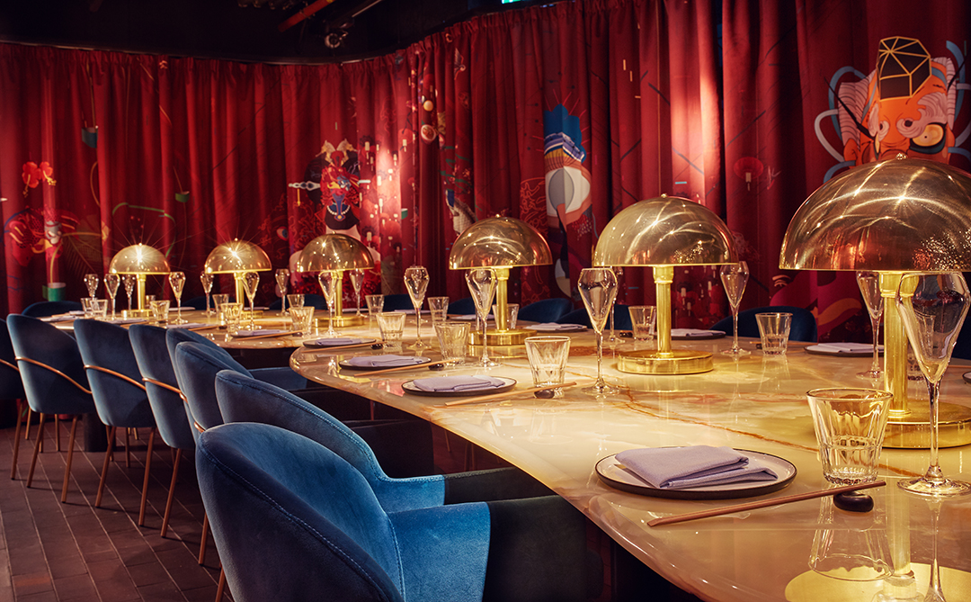 Elegant dining setup in The Rambutan Room for gala and corporate events, gold accents.