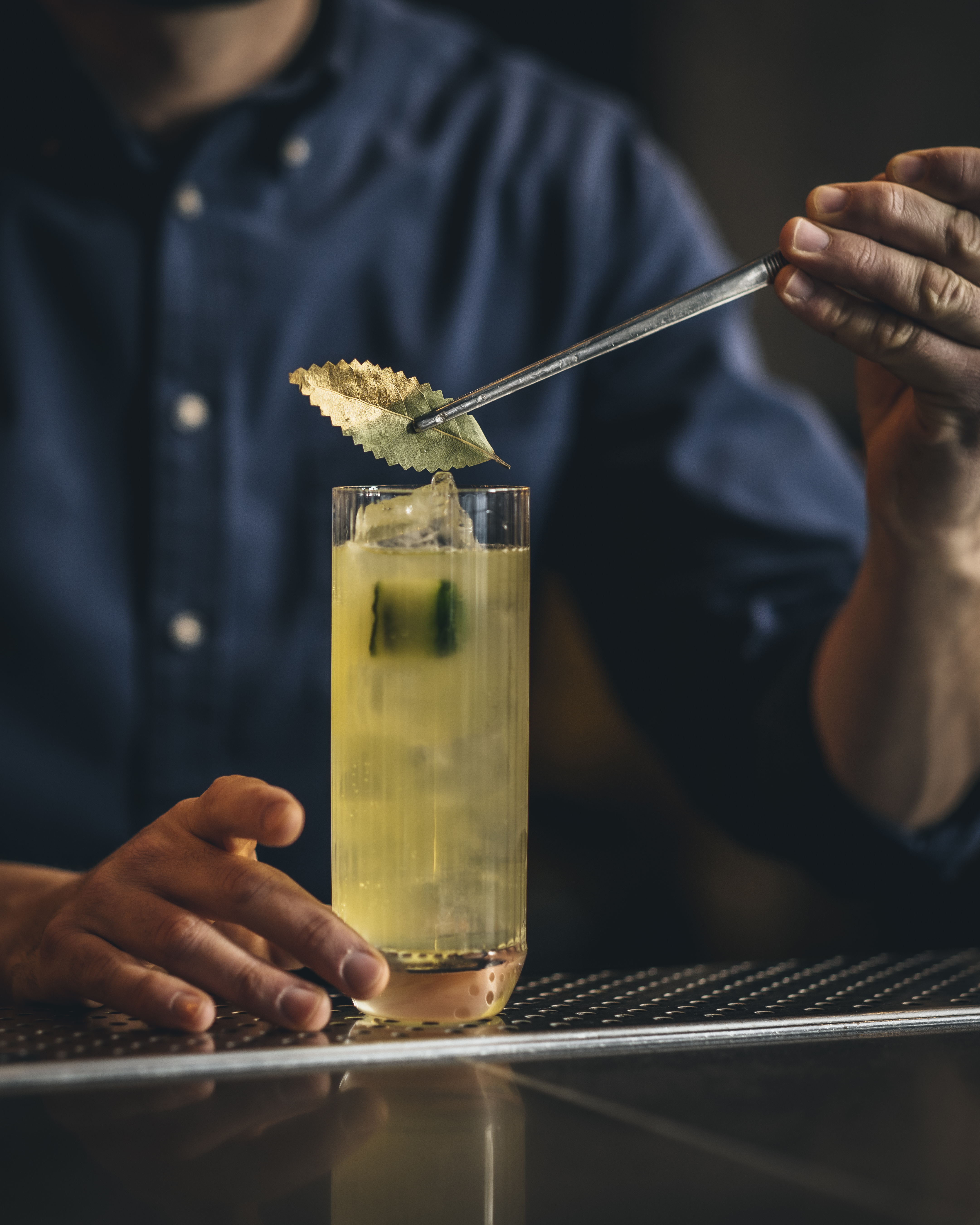 Bartender garnishing a cocktail at Chotto Matte's Bar and Lounge for event catering.