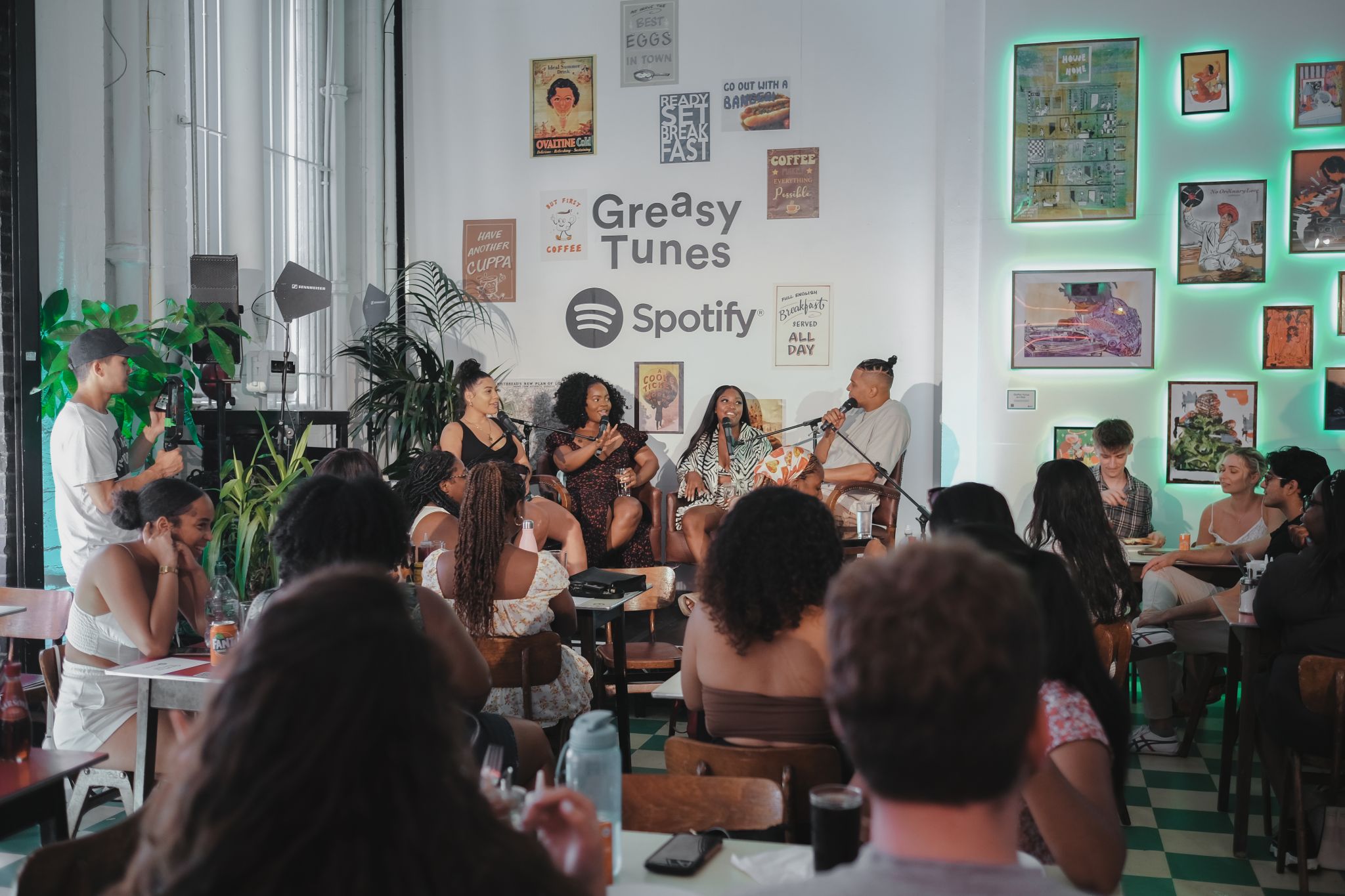 Vibrant live music event in cozy Protein Studios with engaged audience and Spotify branding.