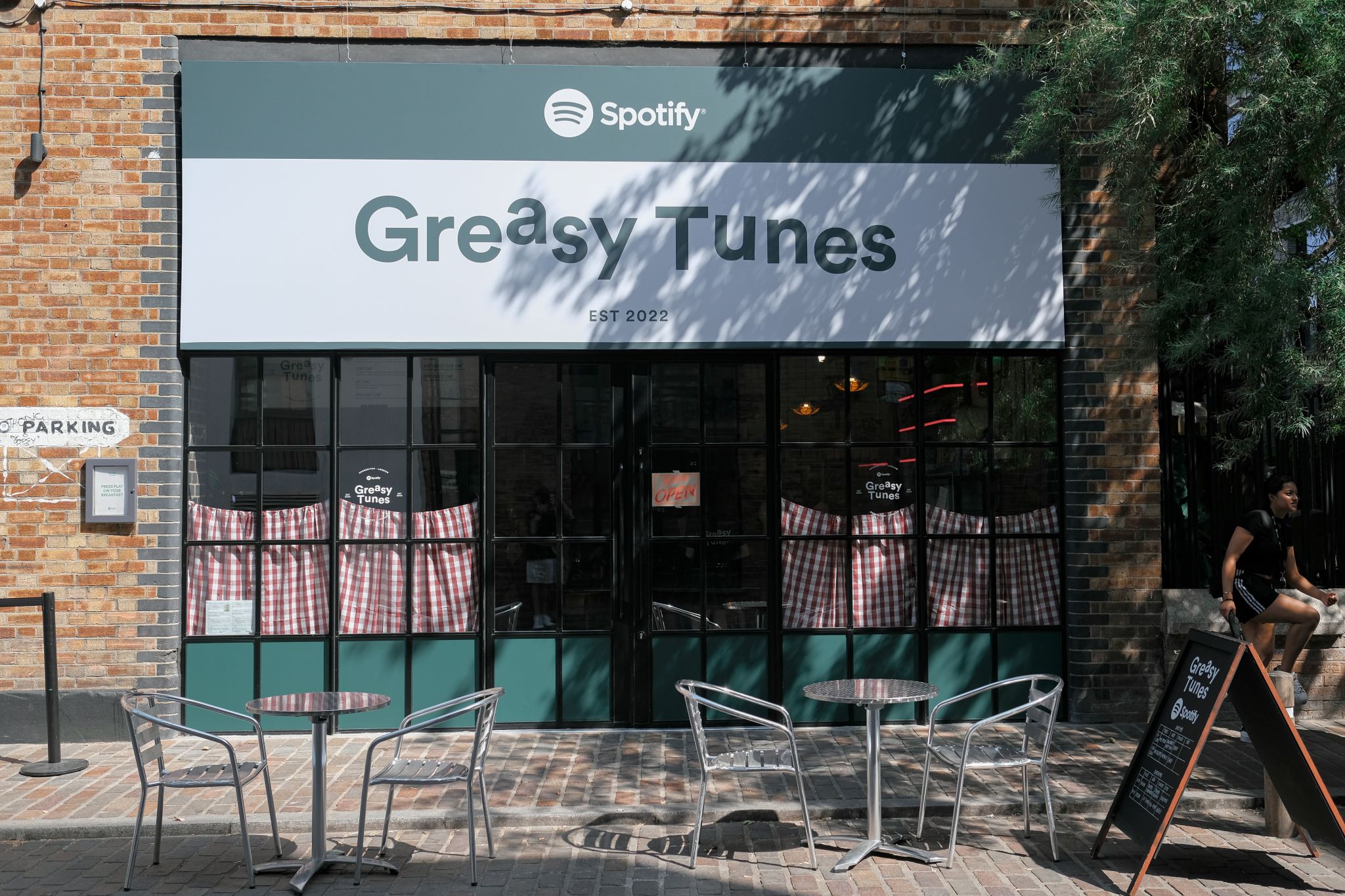 Trendy outdoor venue "Greasy Tunes" at Protein Studios for casual meetups and networking.