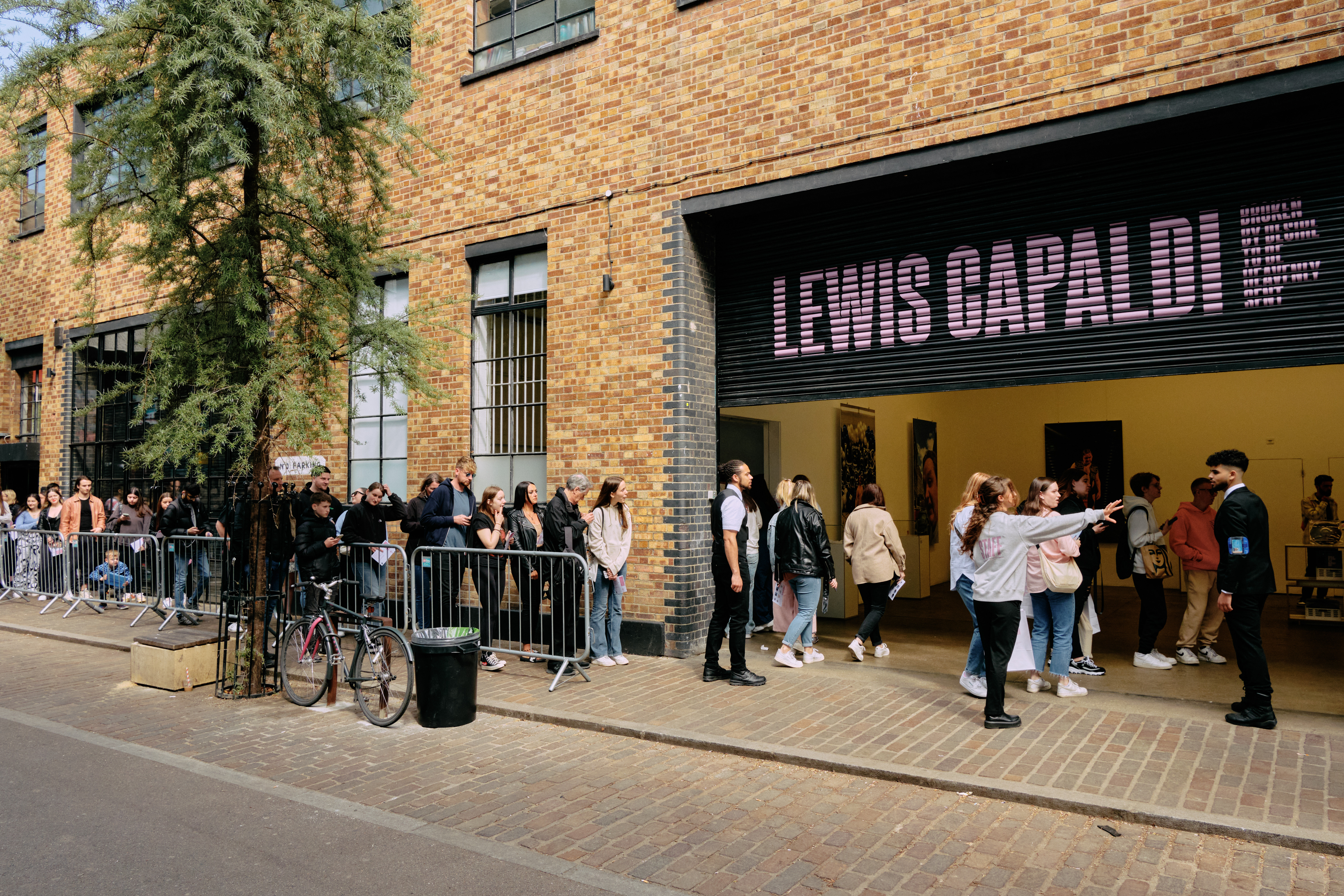 "Studio 1-3 at Protein Studios with vibrant Lewis Capaldi signage and eager attendees."