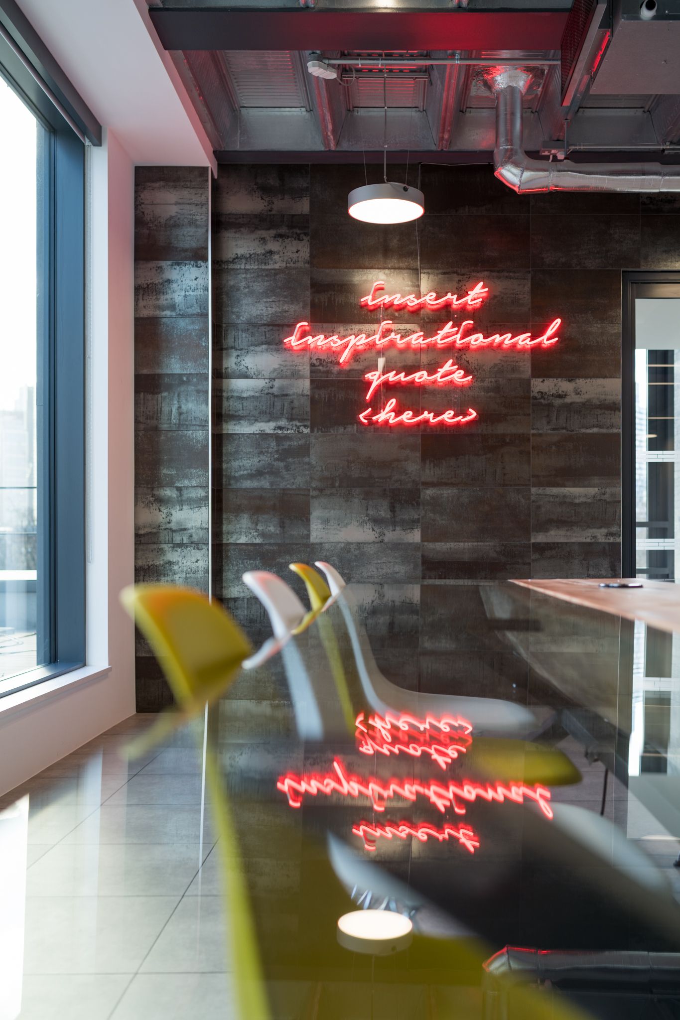 Modern meeting space in London with neon wall, perfect for creative brainstorming events.