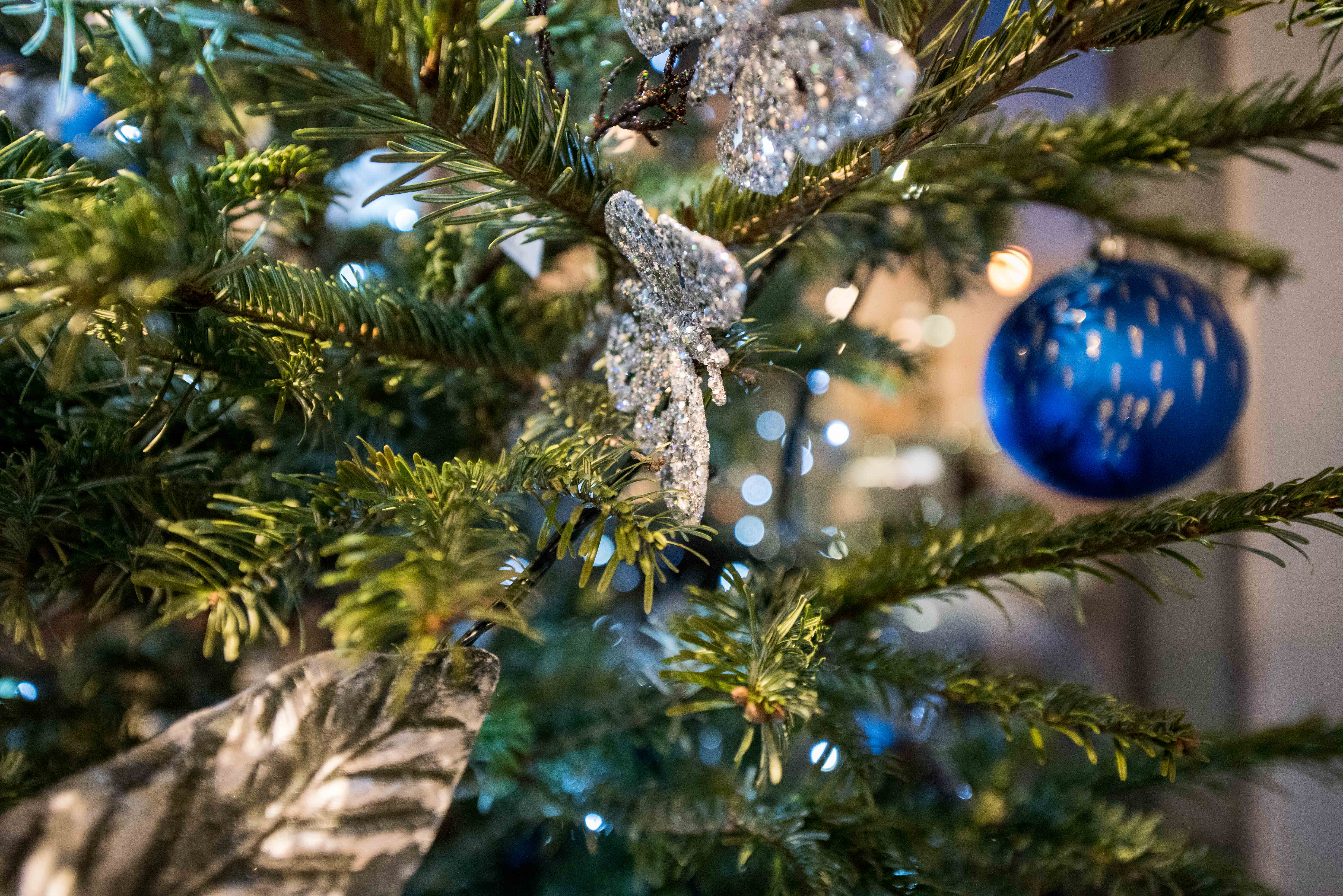 Christmas tree with shimmering ornaments at Holiday Inn Kensington for festive events.