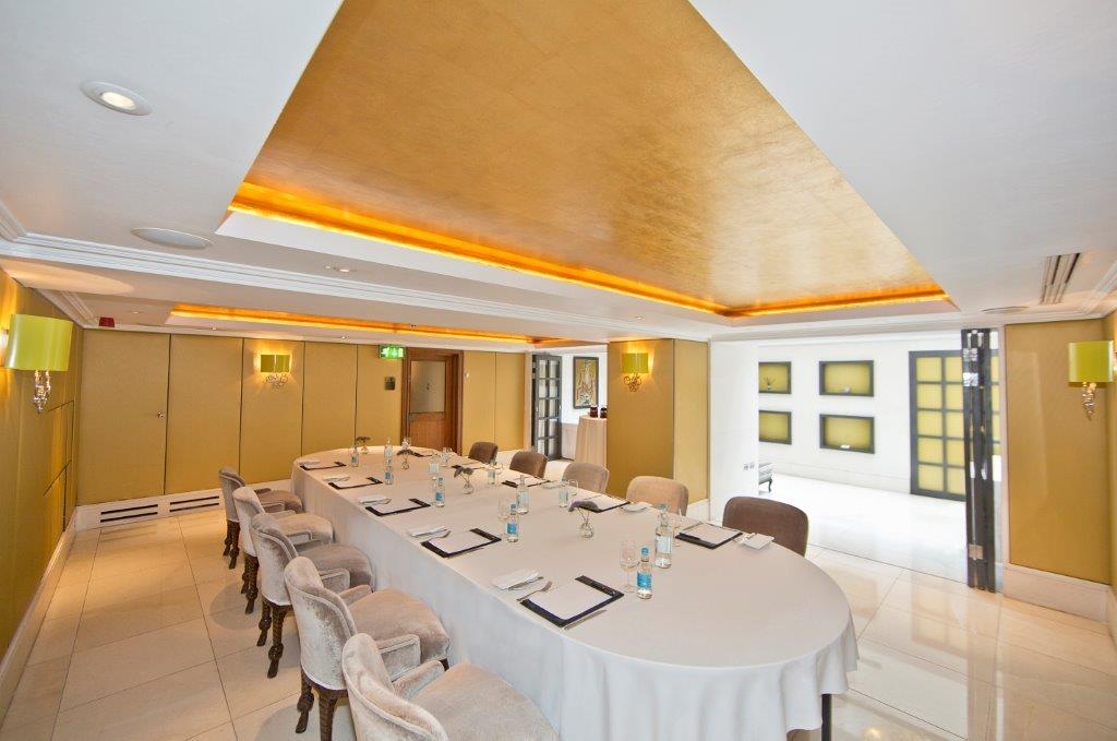 Mayfair Suite meeting room with elegant round table for corporate events and presentations.