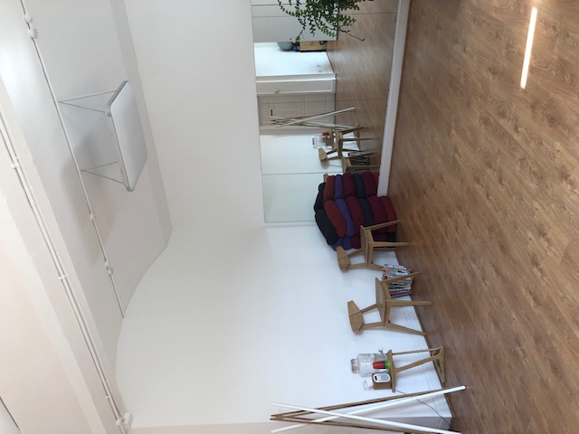 Versatile event space with large mirror, ideal for workshops and yoga sessions.