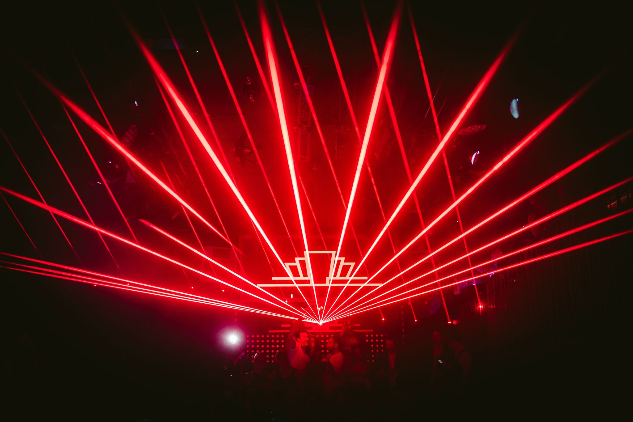The Mezzanine in The London Reign with red laser beams for electrifying nightlife events.