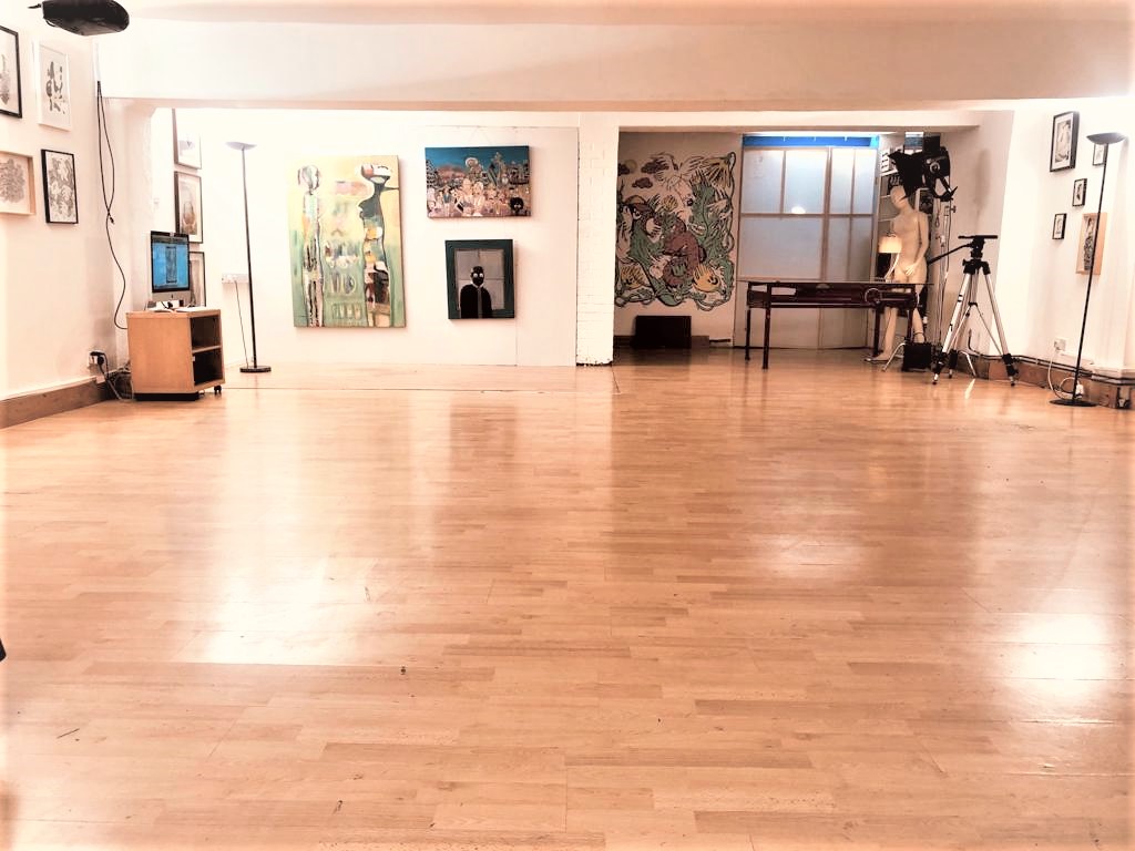 Versatile event space in Dalston Den with polished wooden floors for workshops and exhibitions.
