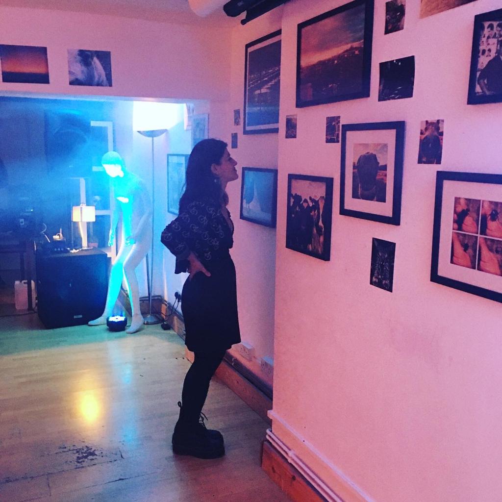 "Dalston Den event space with art wall and blue ambient lighting for networking events."