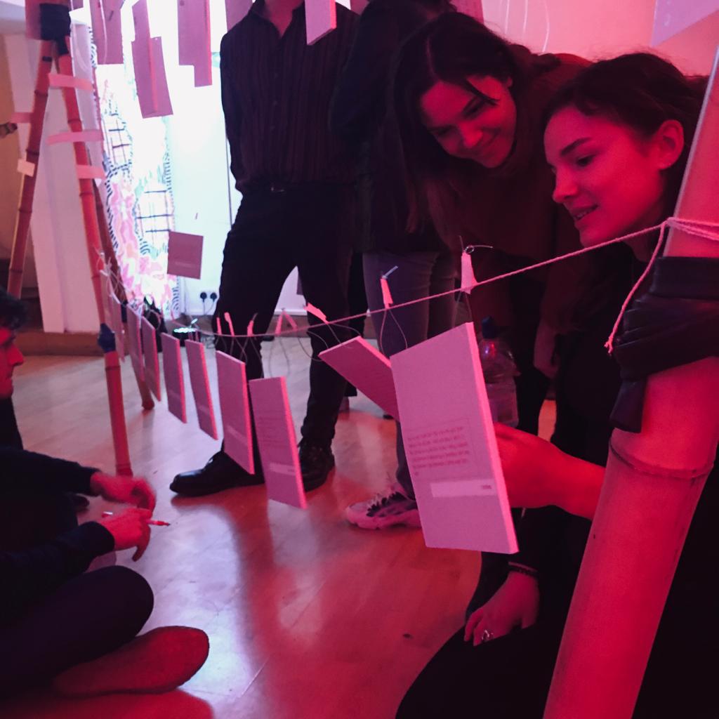 Creative event setup at Dalston Den with string card display for networking and workshops.