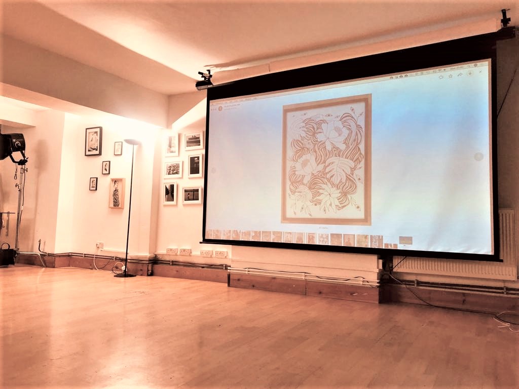 Dalston Den event space with projection screen, ideal for workshops and presentations.