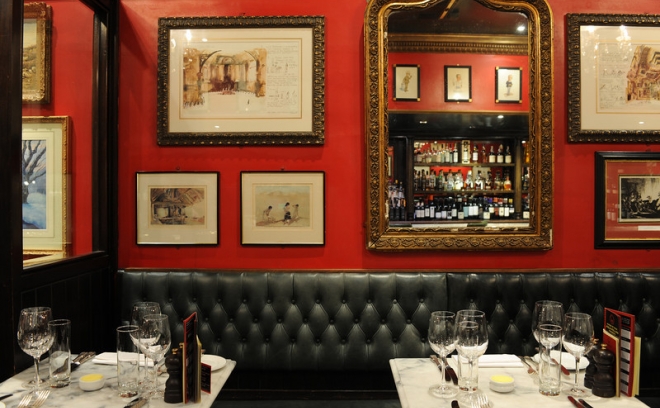 Champagne and Oyster Bar at Boisdale, elegant red decor for upscale events and gatherings.