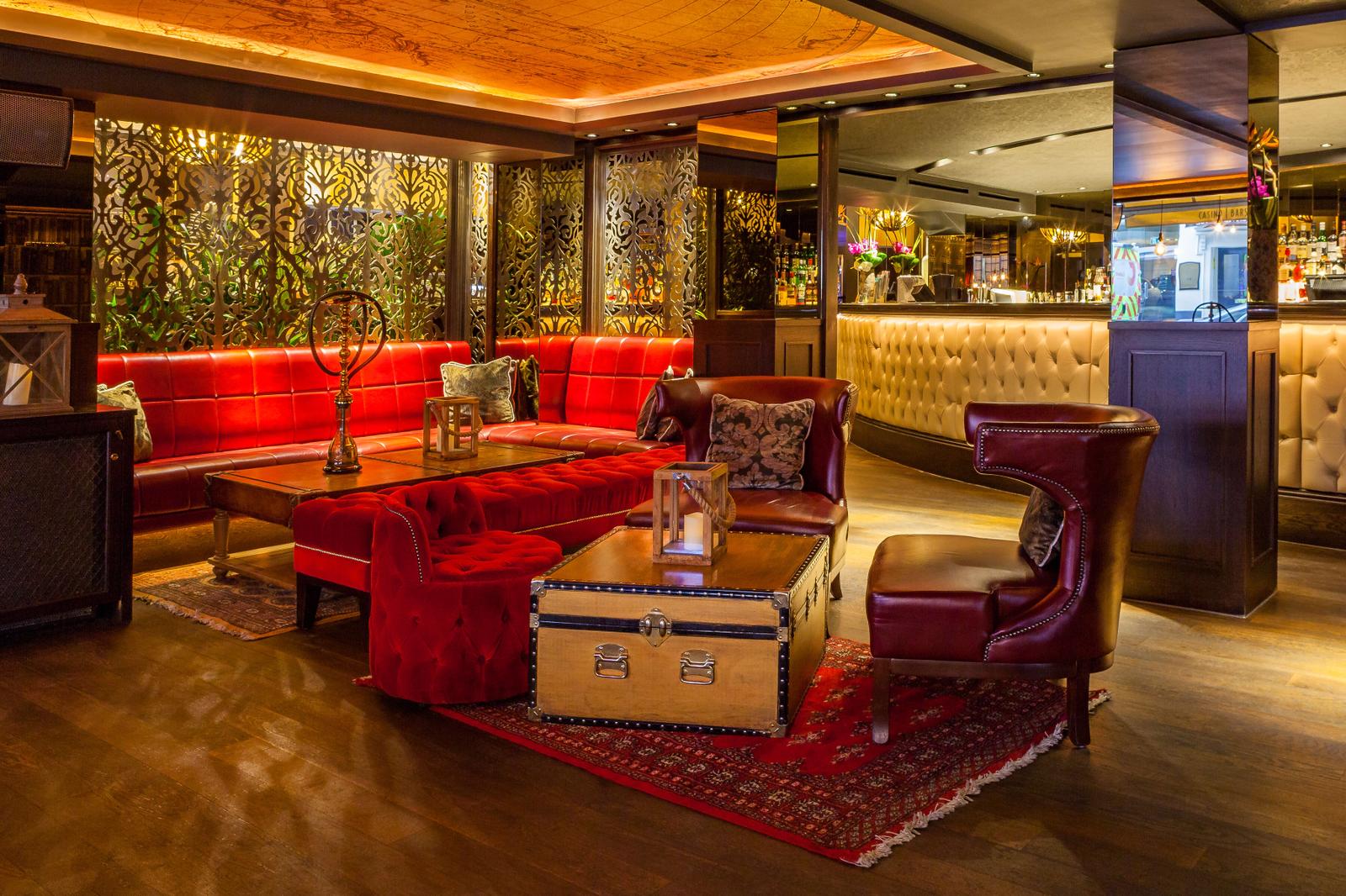 Stylish lounge with red upholstery, ideal for networking events in Palm Beach.