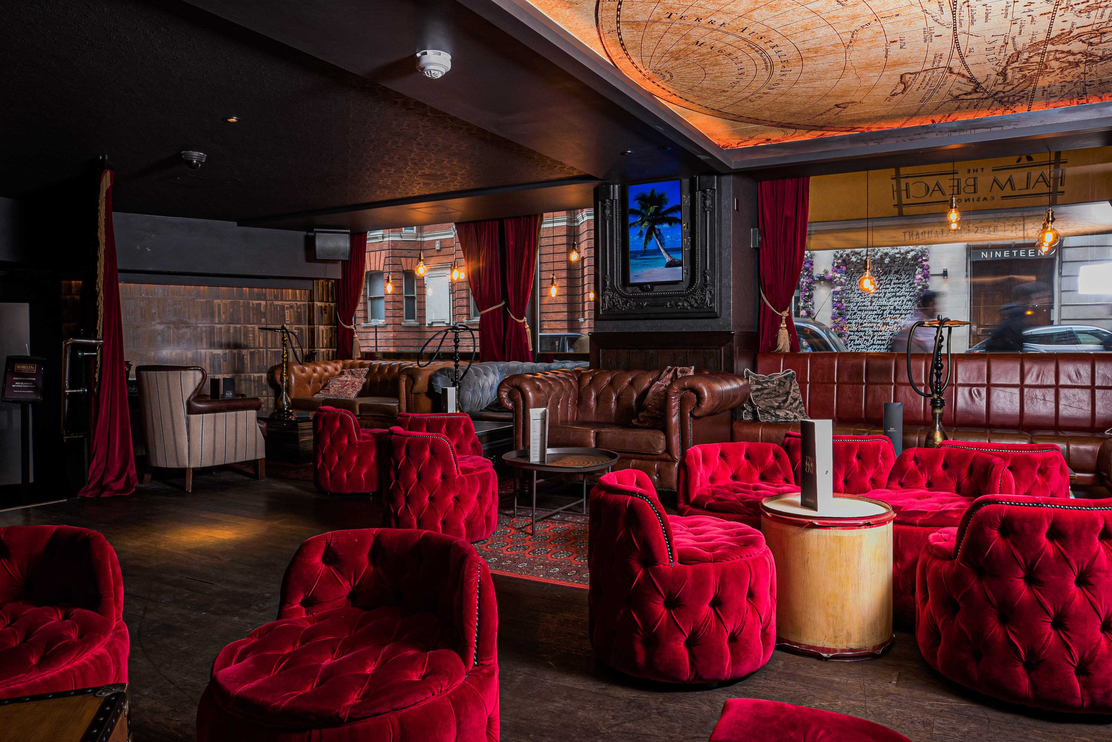 Stylish lounge with plush red seating, ideal for networking events in Palm Beach.