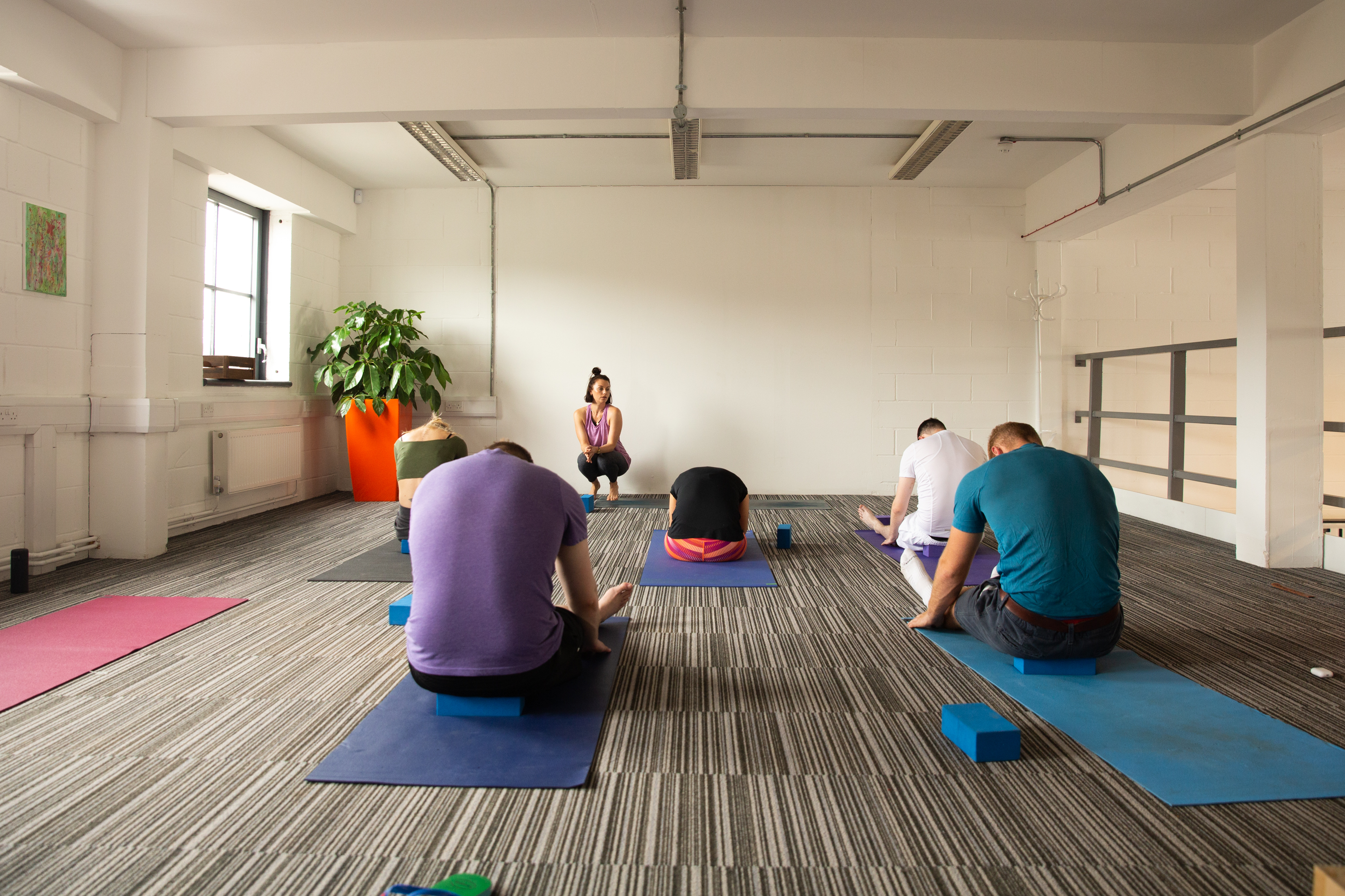 Serene yoga session in spacious Whole Mezzanine, perfect for wellness events and retreats.