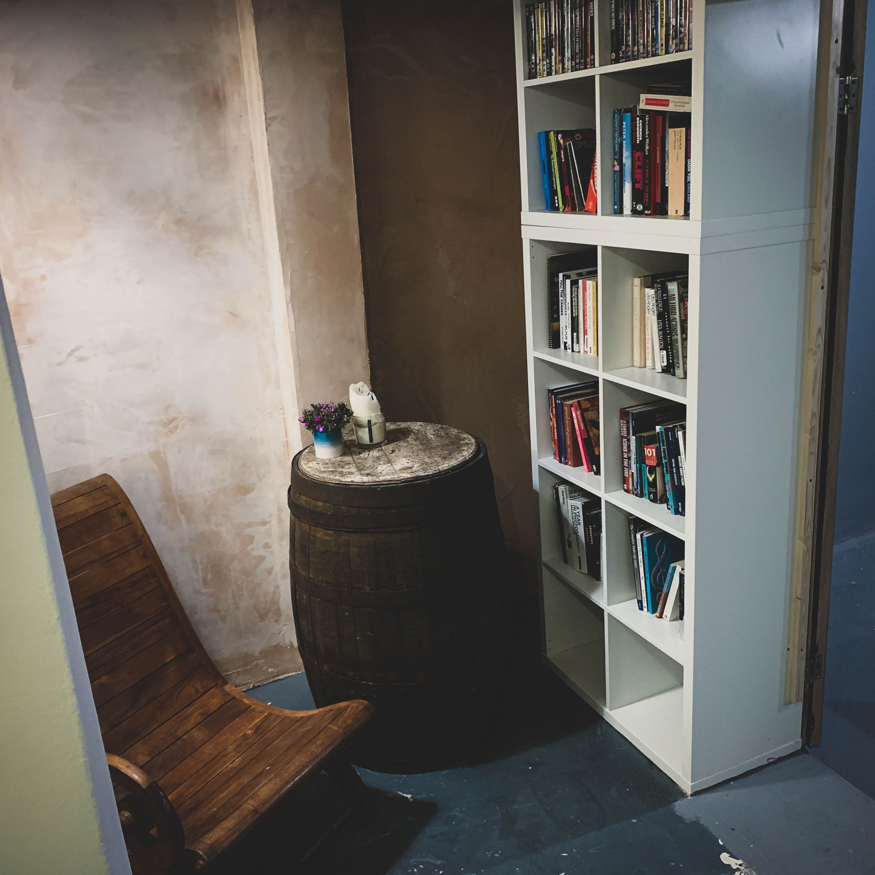 Cozy nook in AE Studio with rustic barrel table for informal meetings and brainstorming.