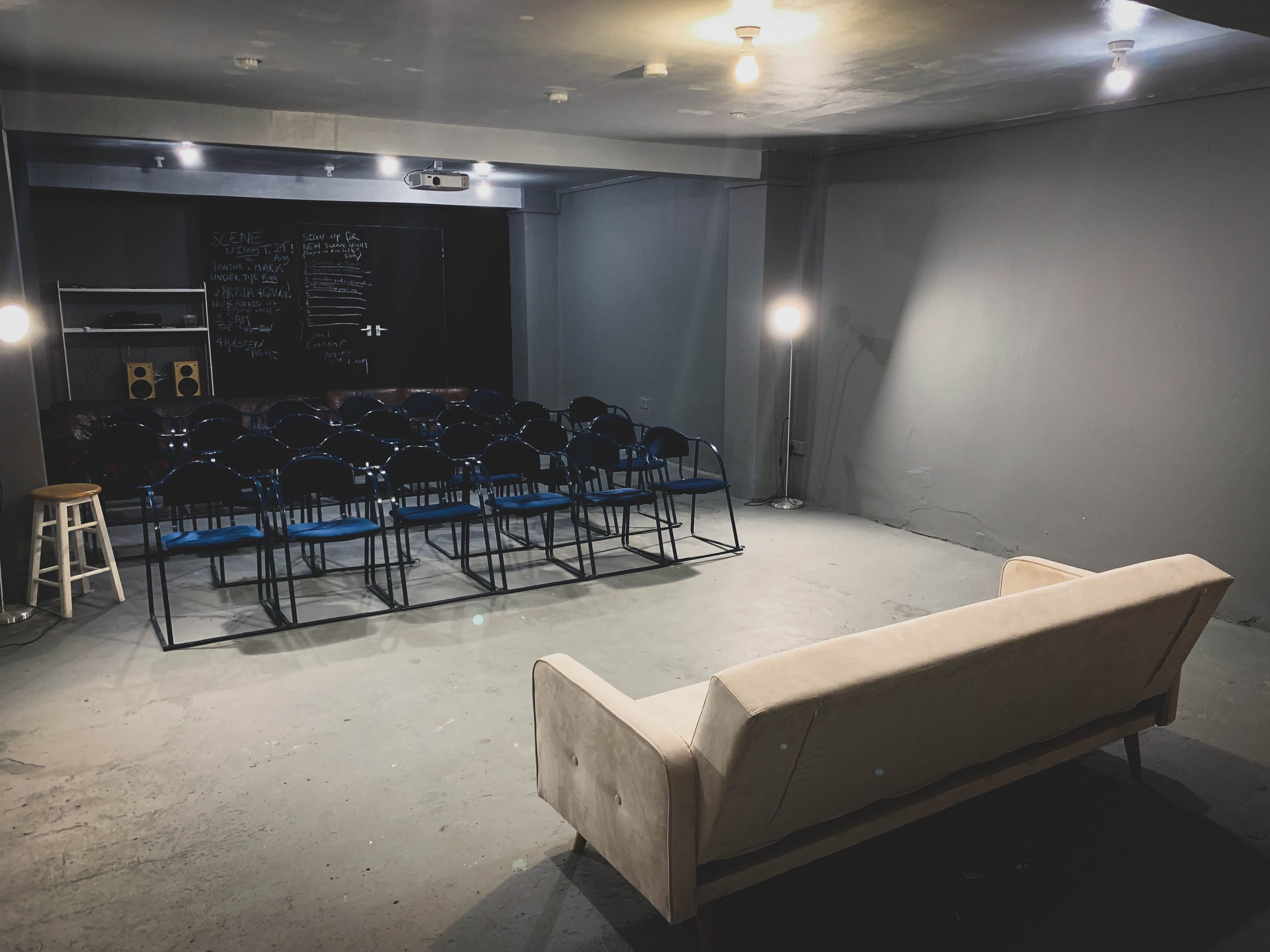 Versatile event space in AE Studio with minimalist setup for workshops and gatherings.