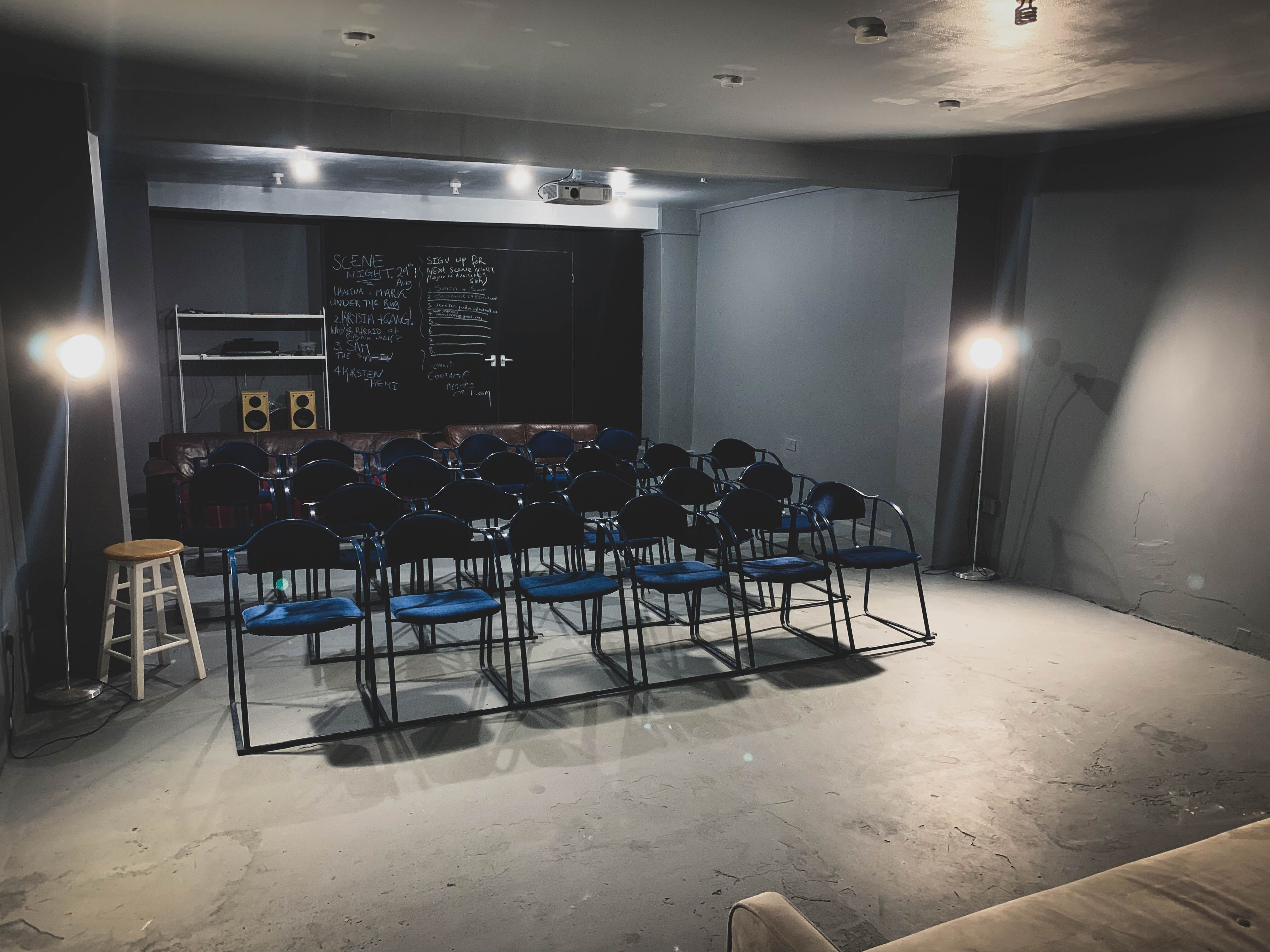Minimalist event space with blue chairs, perfect for meetings and workshops.