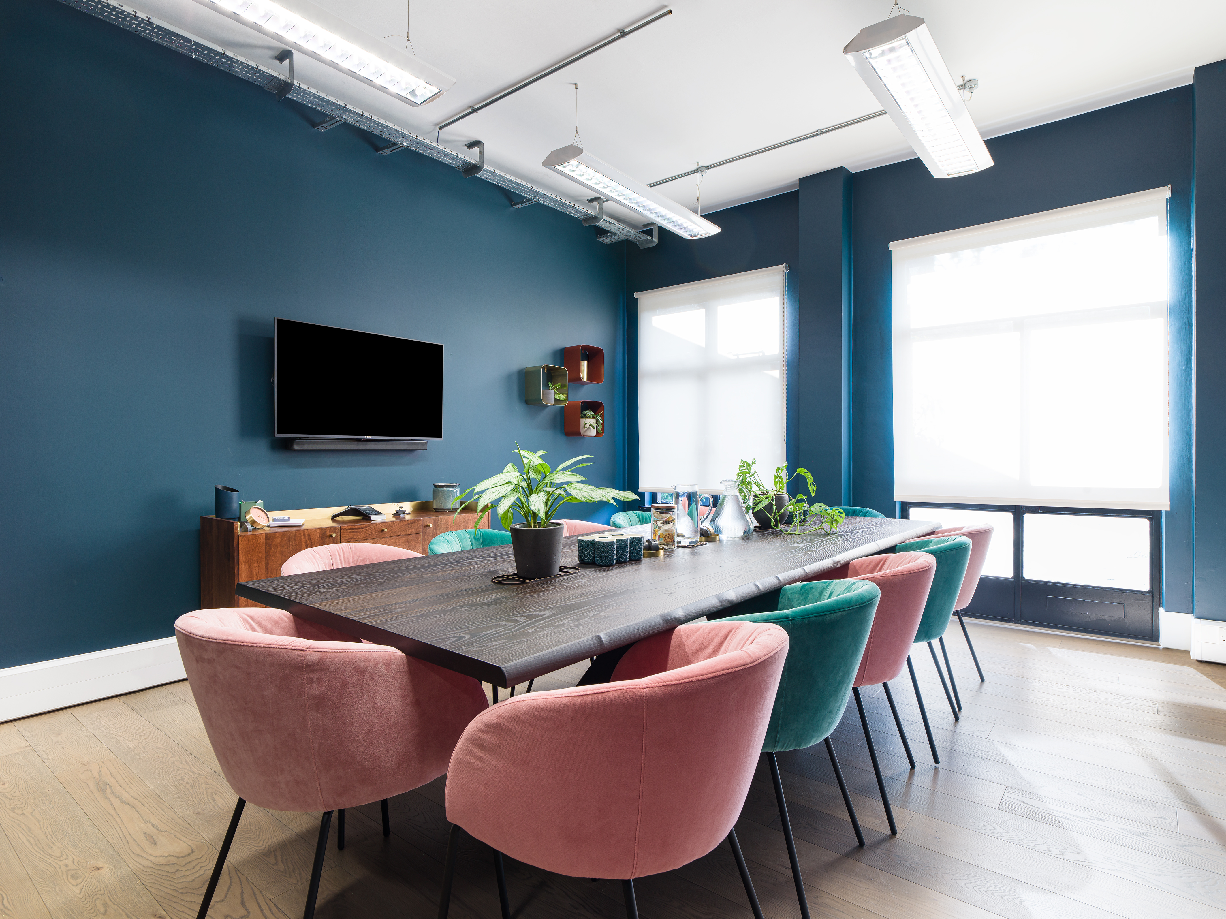 Modern meeting room with colorful chairs, ideal for collaboration and presentations.