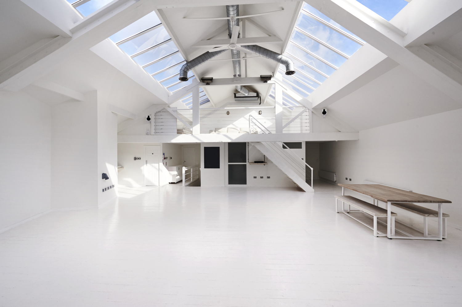Bright loft venue with high ceilings for corporate events and creative workshops.