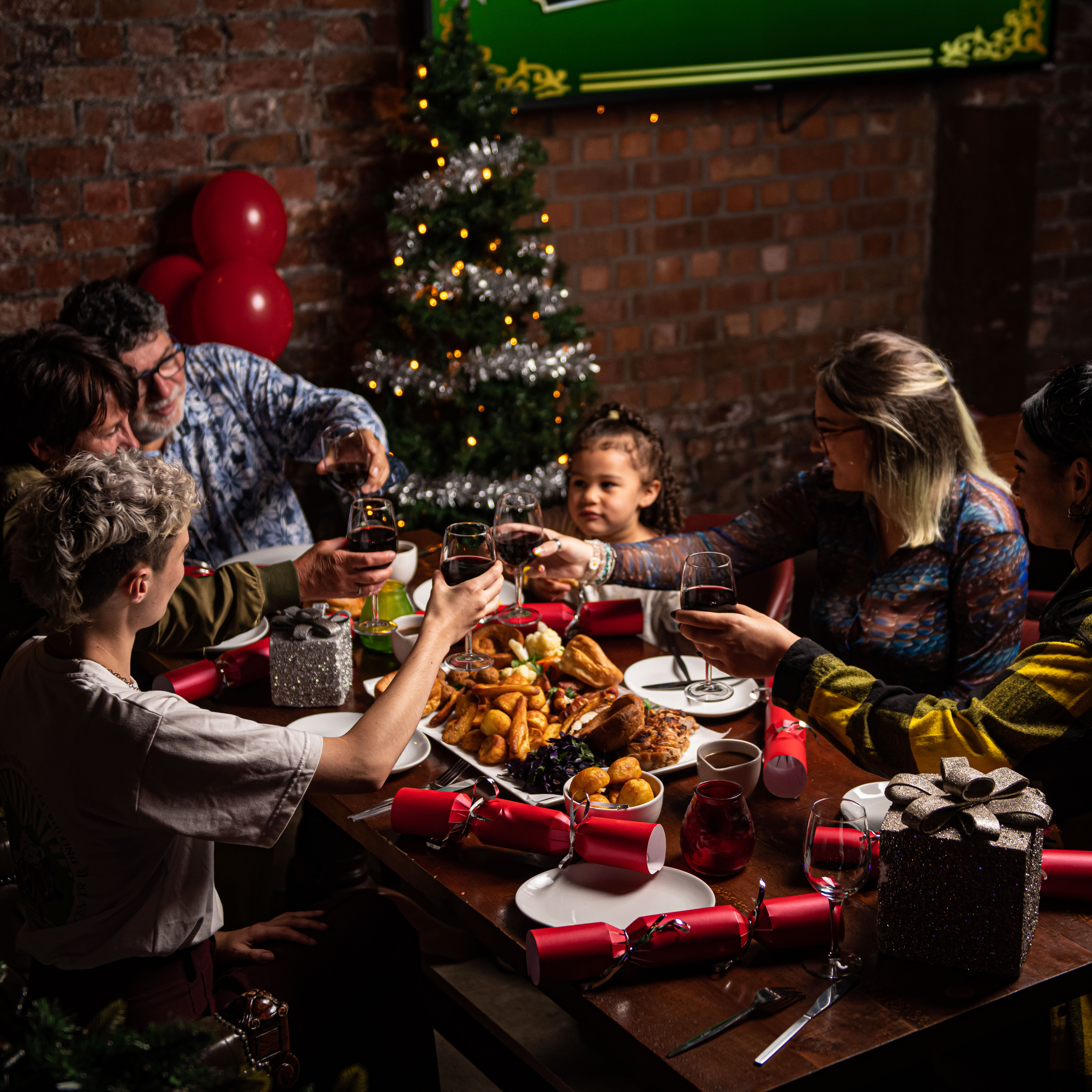 Festive gathering at Quarter Hoop, Liverpool with Christmas tree and joyful toasts.