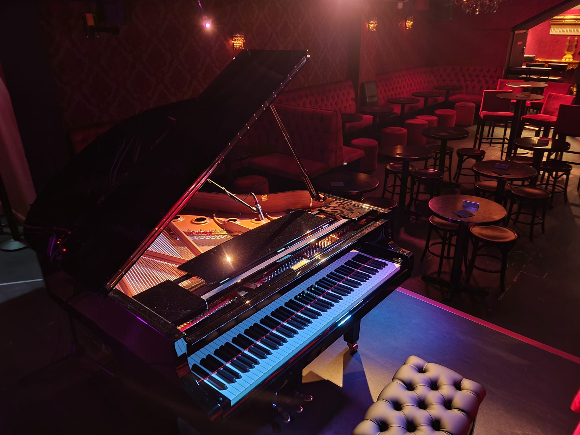 Elegant grand piano stage at Whole Venue, ideal for live performances and upscale events.