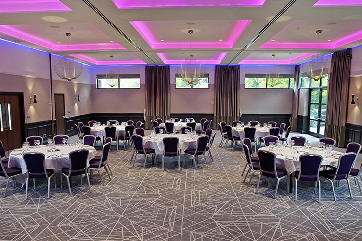 Elegant Princess Suite banquet setup with round tables, perfect for events and celebrations.