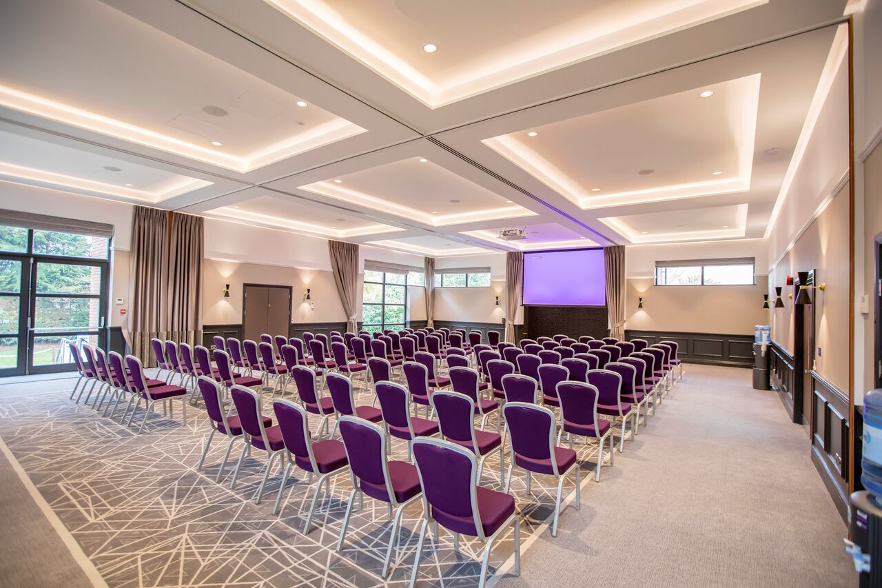 Princess Suite at Denham Grove with purple chairs for meetings and events.