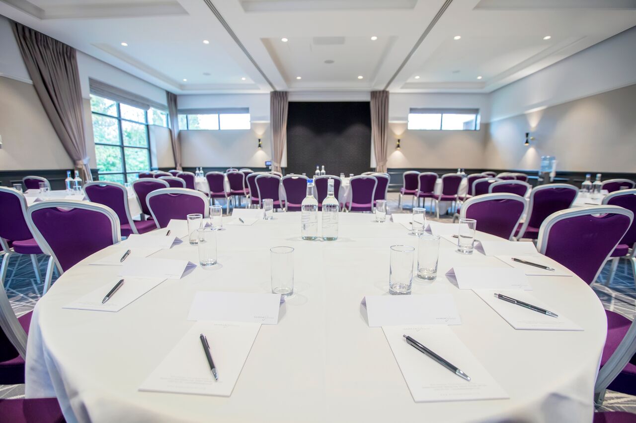 Elegant Princess Suite meeting room with round tables, perfect for corporate events.