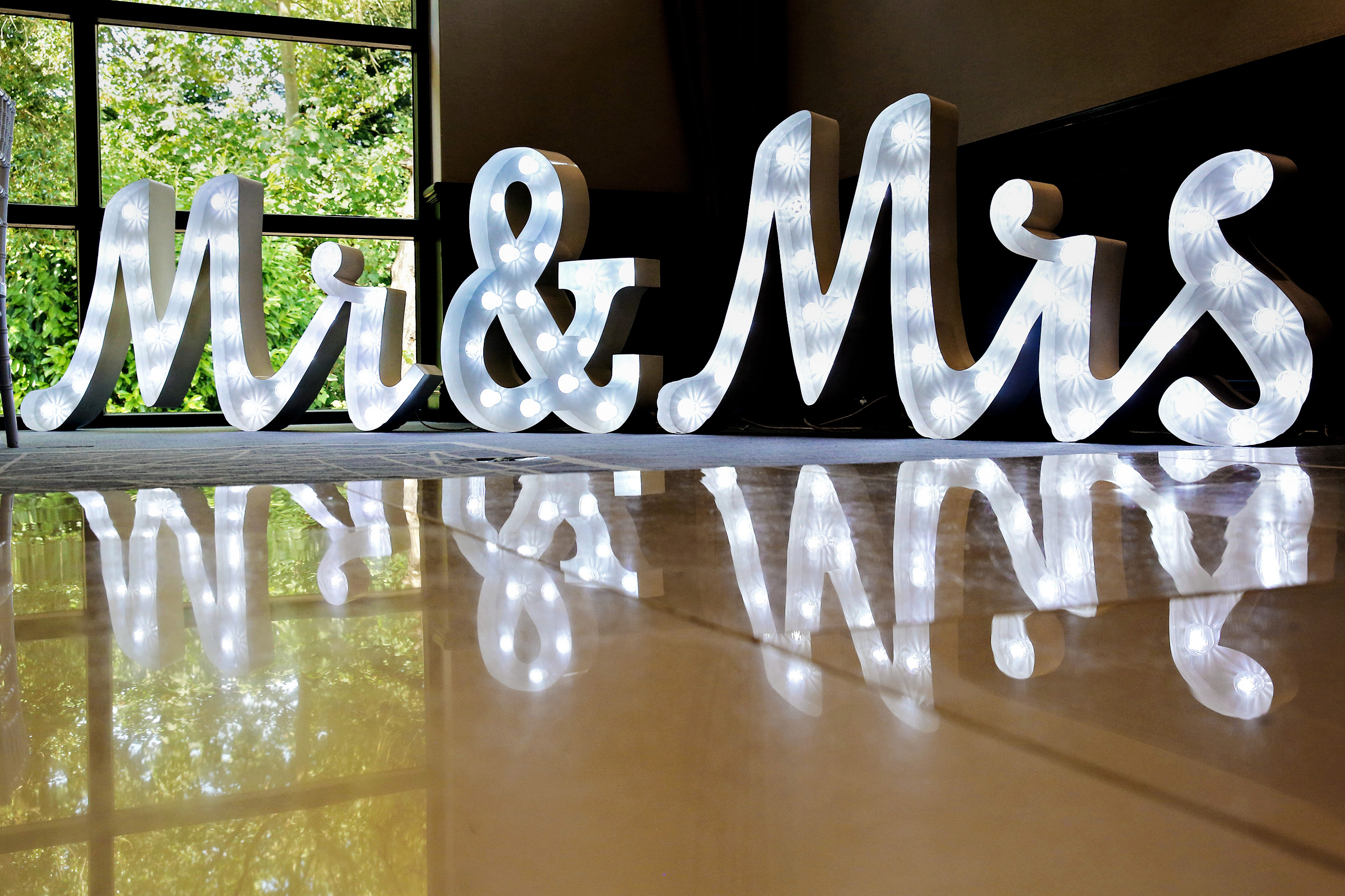 "Illuminated Mr & Mrs sign in Denham Grove's Princess Suite for romantic weddings."
