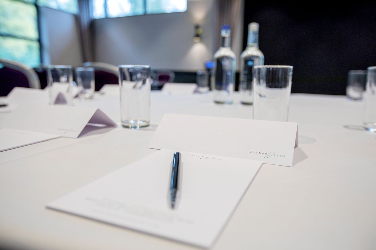 Princess Suite meeting setup with organized table, name cards, and water bottles.