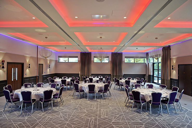 Princess Suite at Denham Grove, elegant banquet setup with purple accents for events.